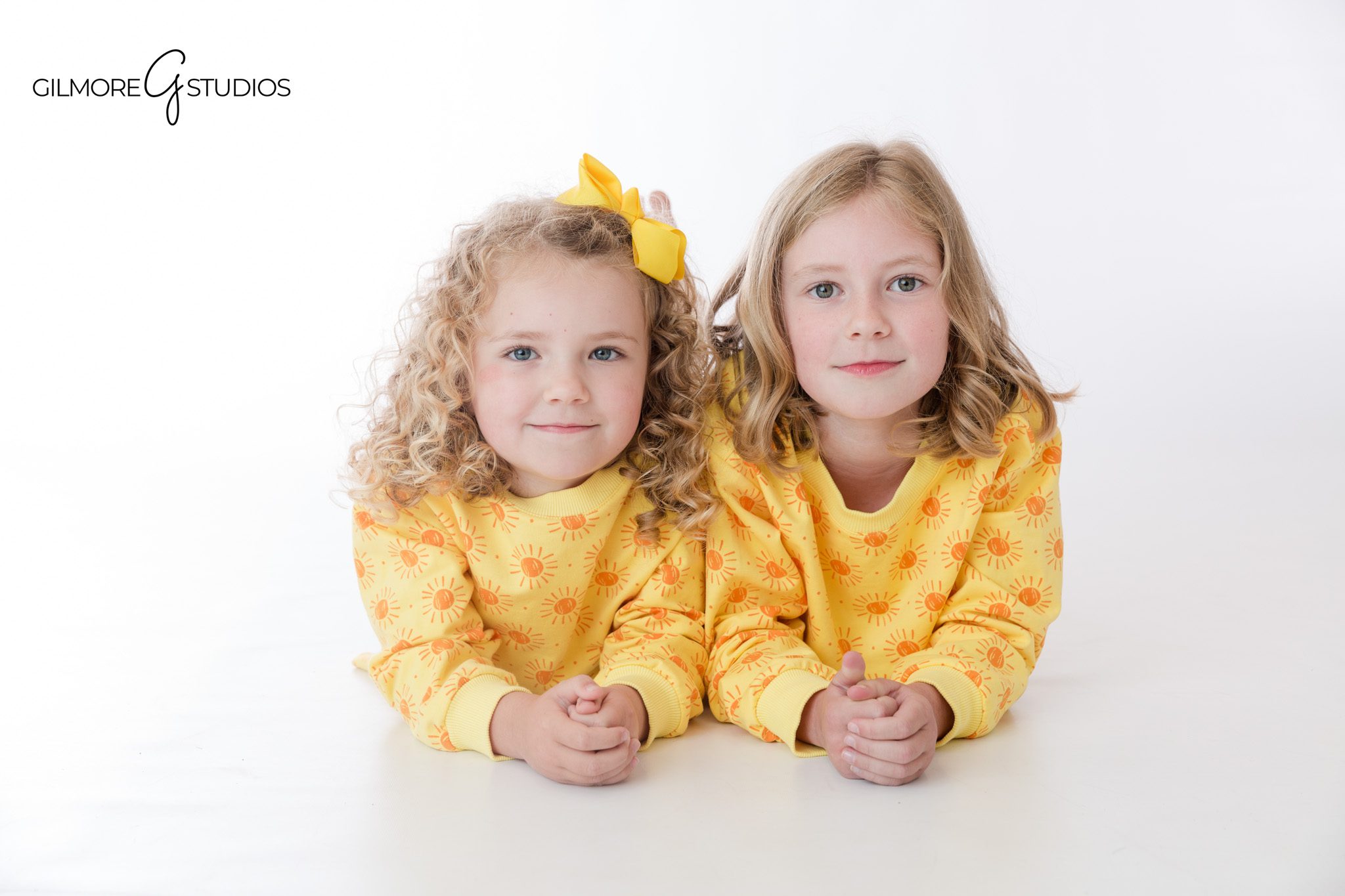 Classic white studio photos for siblings in Newport Beach
Children’s portrait session with sisters in coordinated outfits