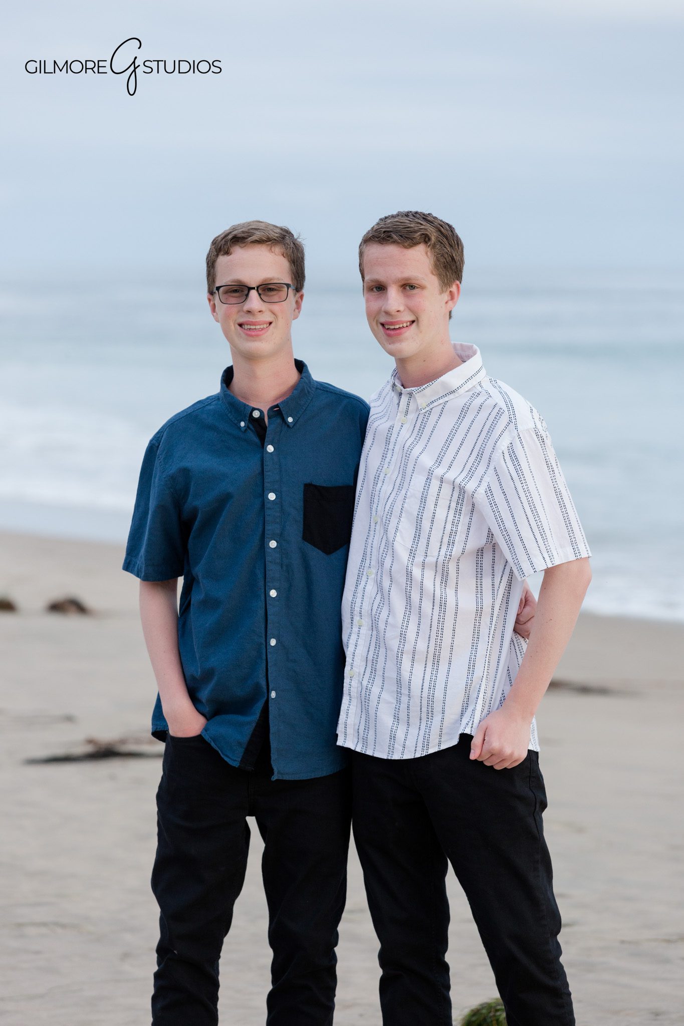 Senior boys standing side by side near the ocean at Crystal Cove
Individual and matching senior portraits for twins in Newport Beach
