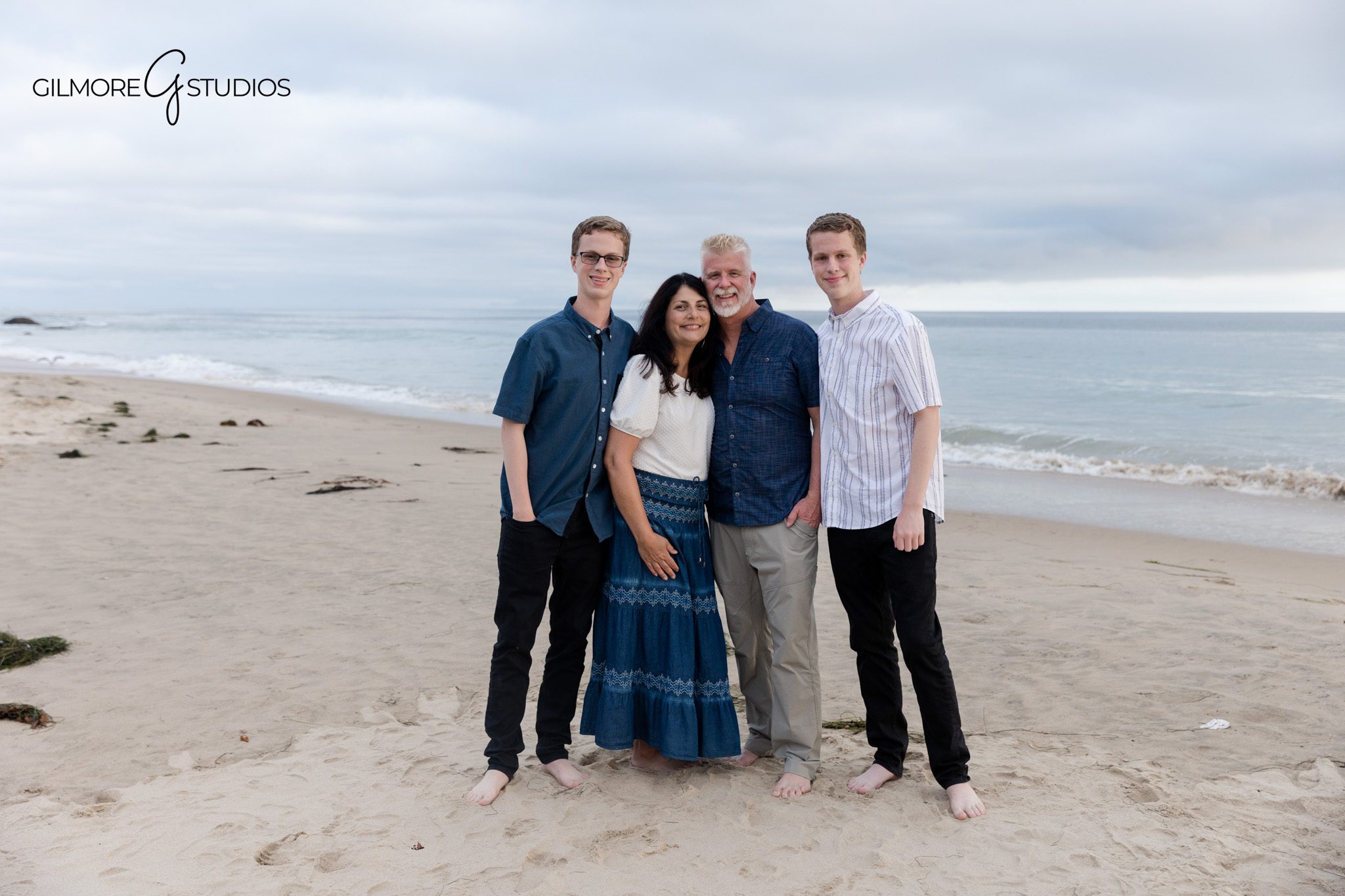 Family of four standing on the sand at Crystal Cove
Newport Beach beach portrait session with older kids