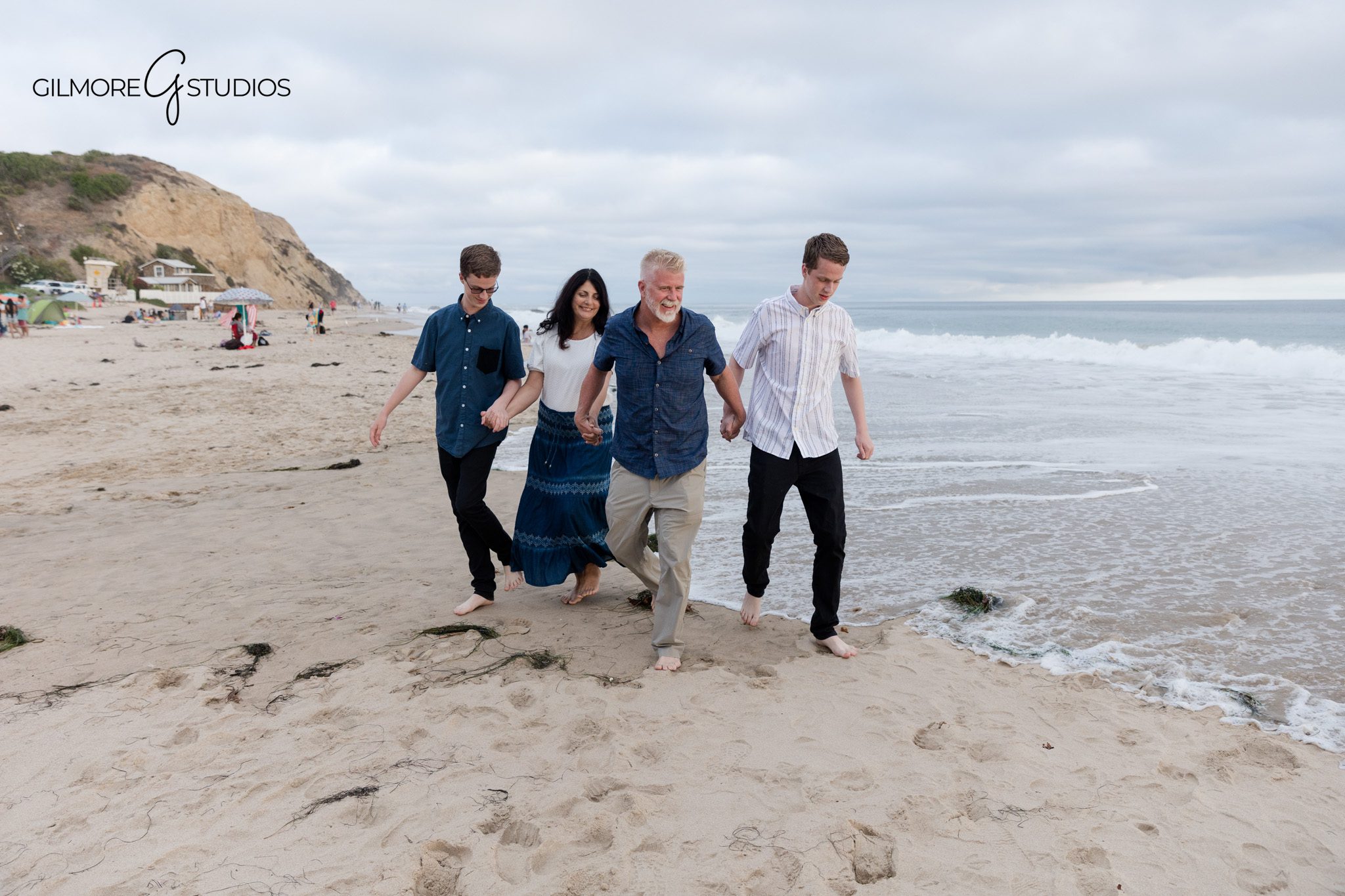 Relaxed Newport Beach family portraits with older sons
Senior portrait session with family walking along the shoreline