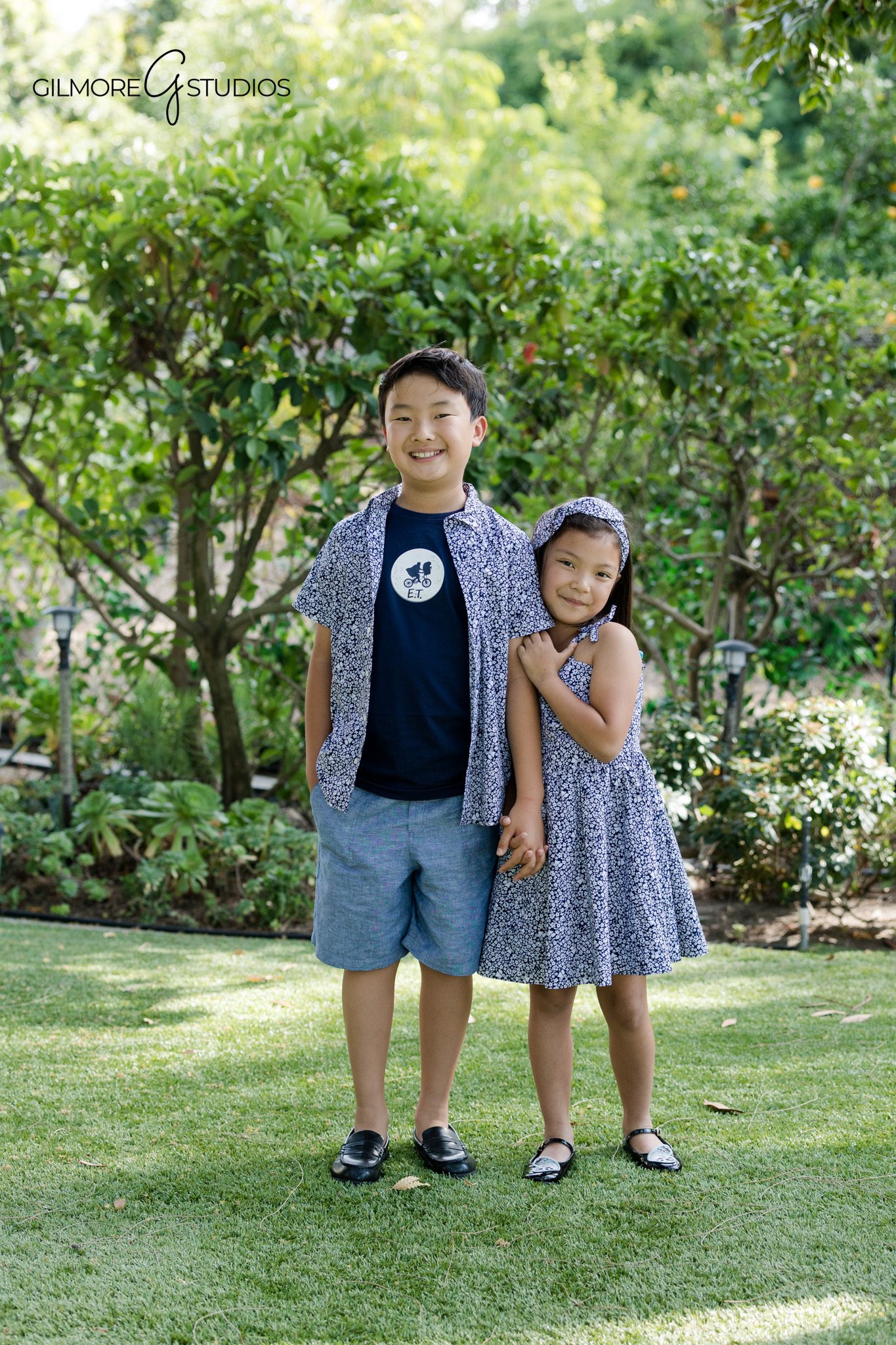 Girl in blue floral dress posing for studio portrait
Classic children's studio photography by Gilmore Studios