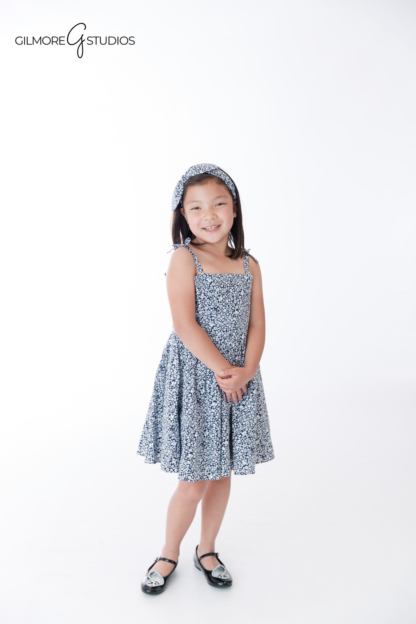 Newport Beach children's portraits with matching blue floral outfits
Garden portrait of siblings smiling together in Newport Beach