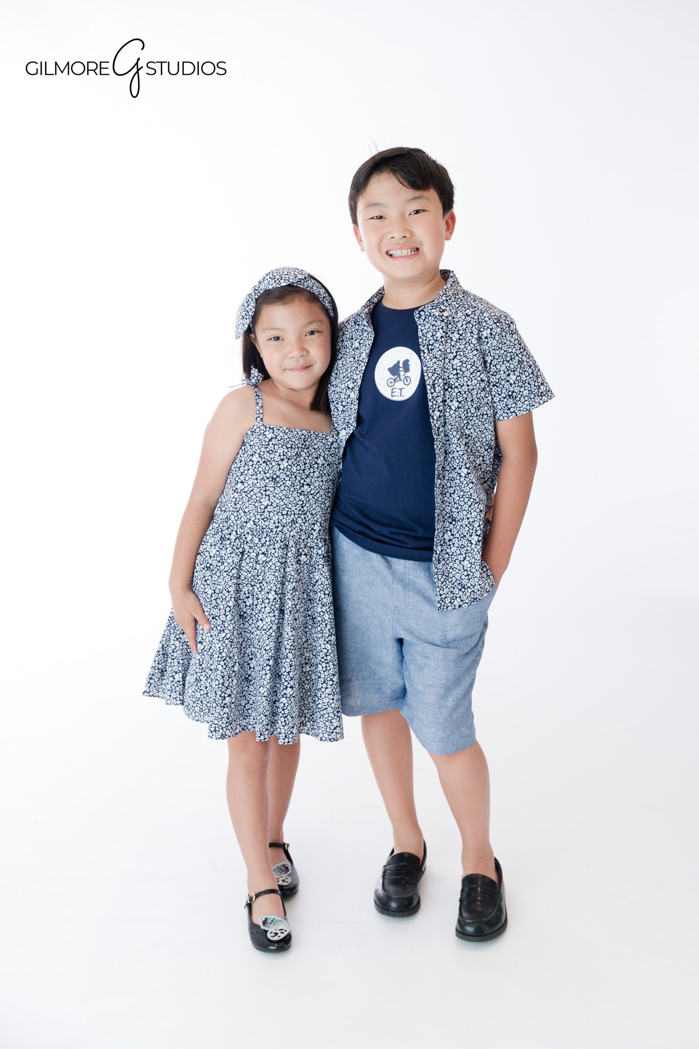 Outdoor sibling session with brother and sister standing in greenery
Gilmore Studios children's photography in Newport Beach garden setting