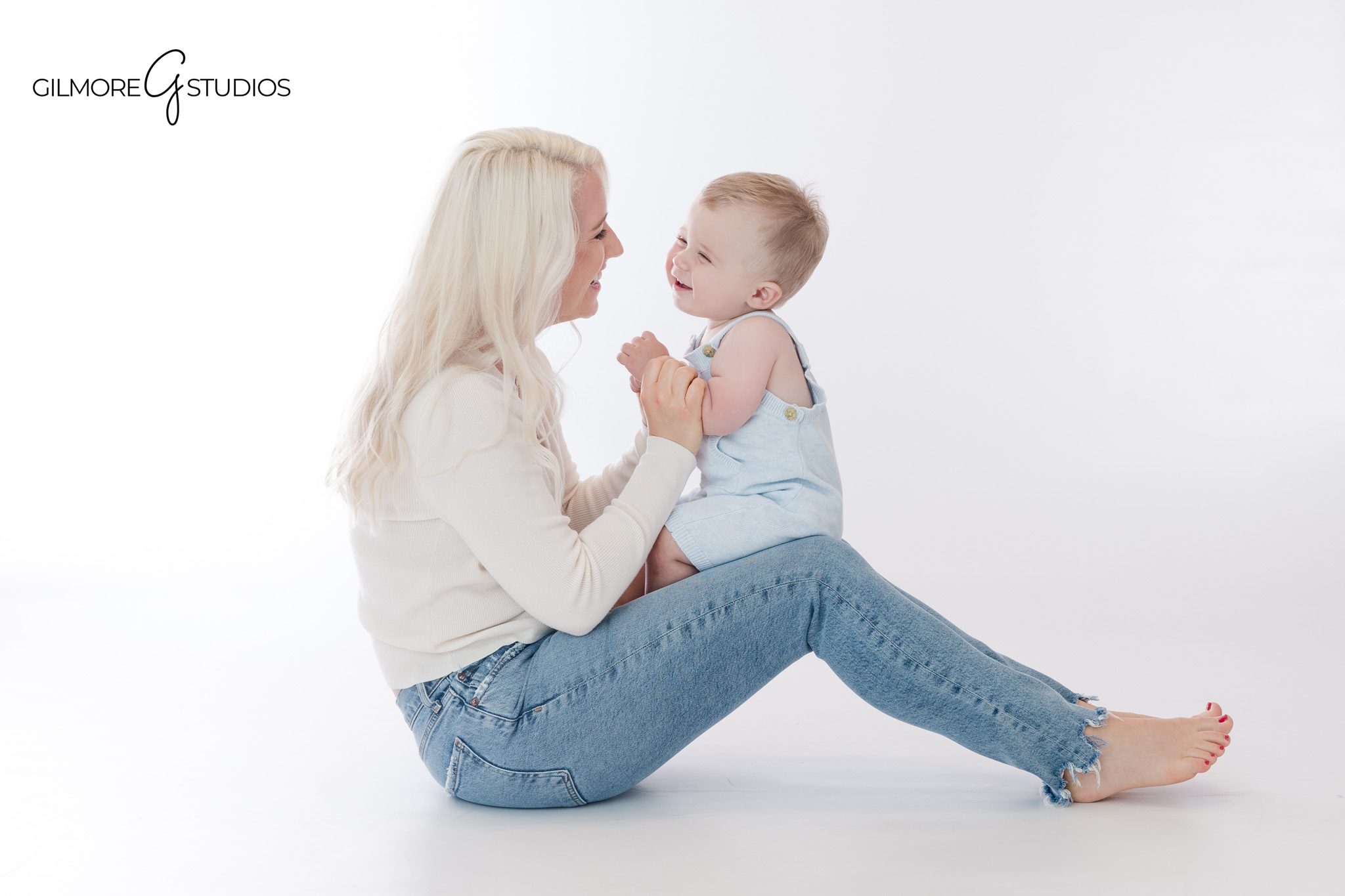 Baby boy crawling toward white teddy bear during studio session
Simple baby portrait before teddy bear cake smash photos