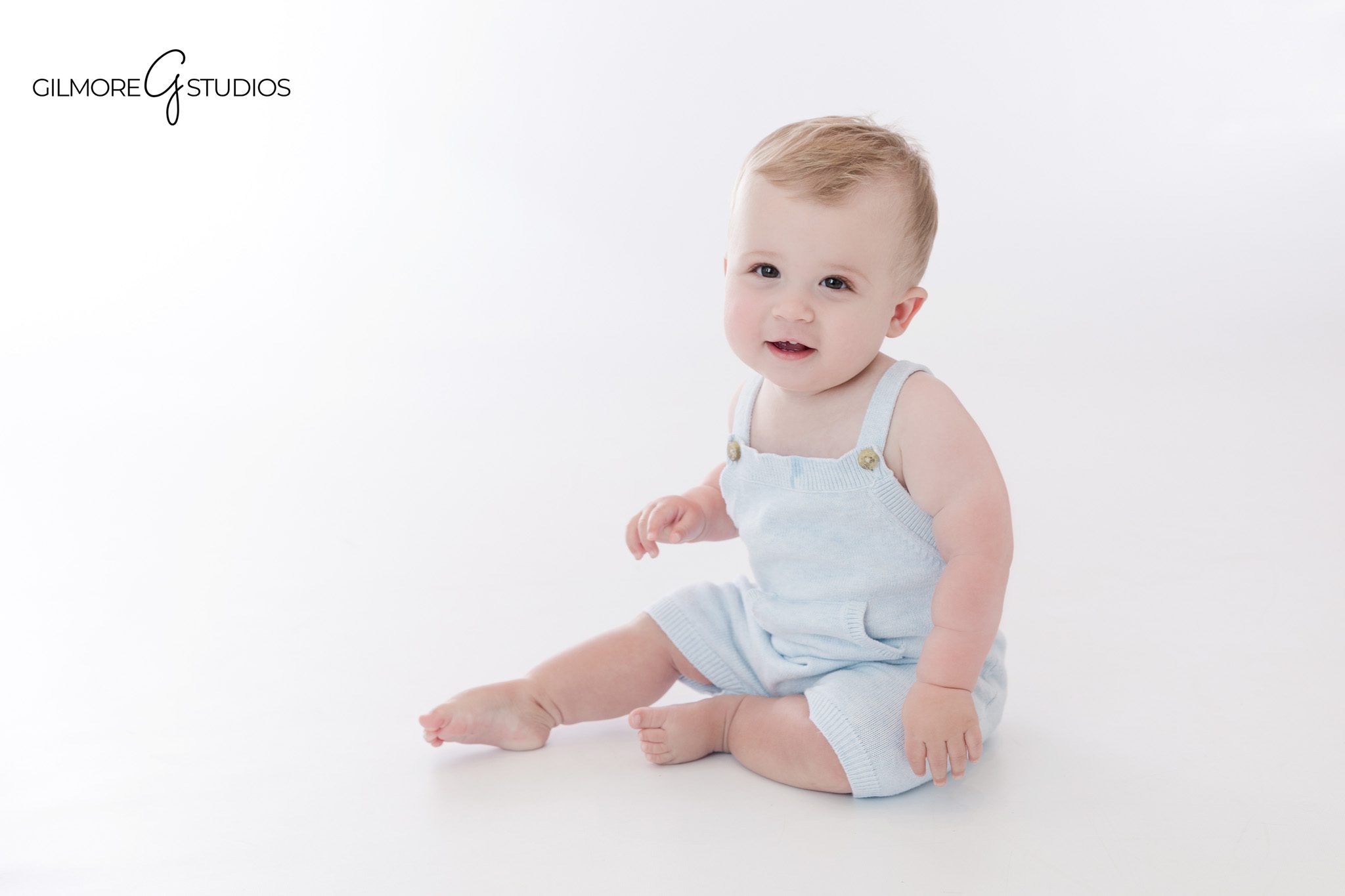 One year old sitting with stuffed animals during first birthday session
Teddy bear milestone portrait for baby boy in Queen Creek AZ