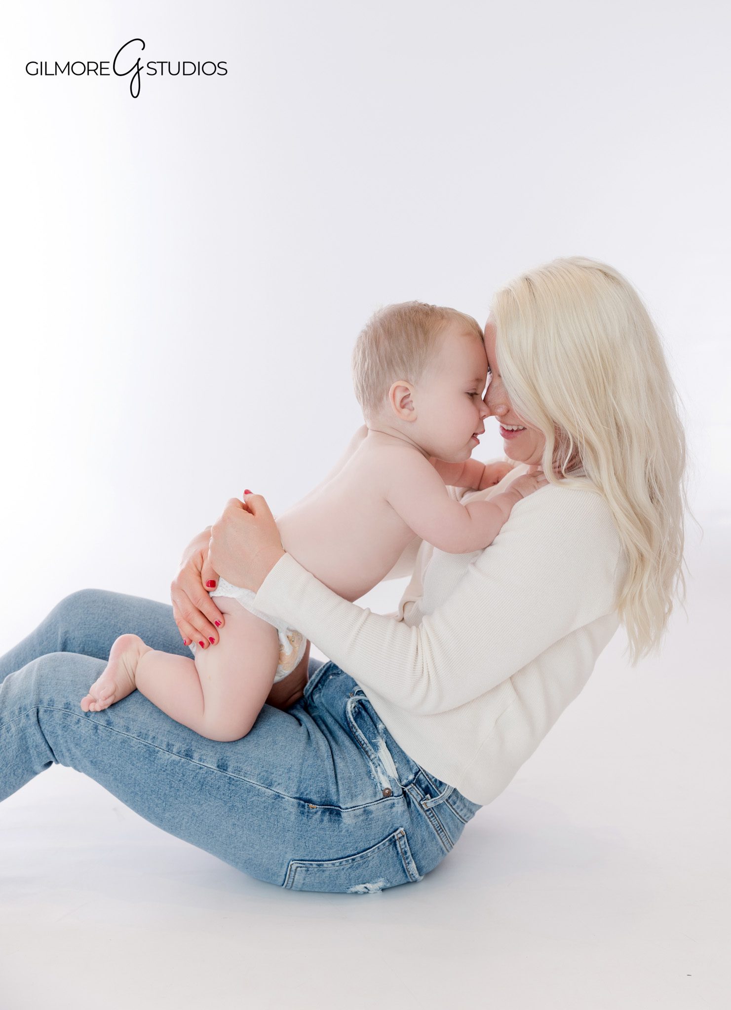 One year old boy playing with stuffed bear during milestone session
Queen Creek baby milestone photos with simple white studio backdrop