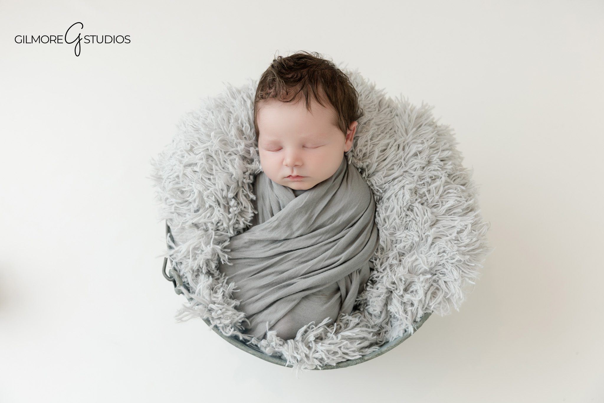 Studio newborn session in Queen Creek with baby wrapped in soft gray
Newborn baby portrait with mom on clean white backdrop