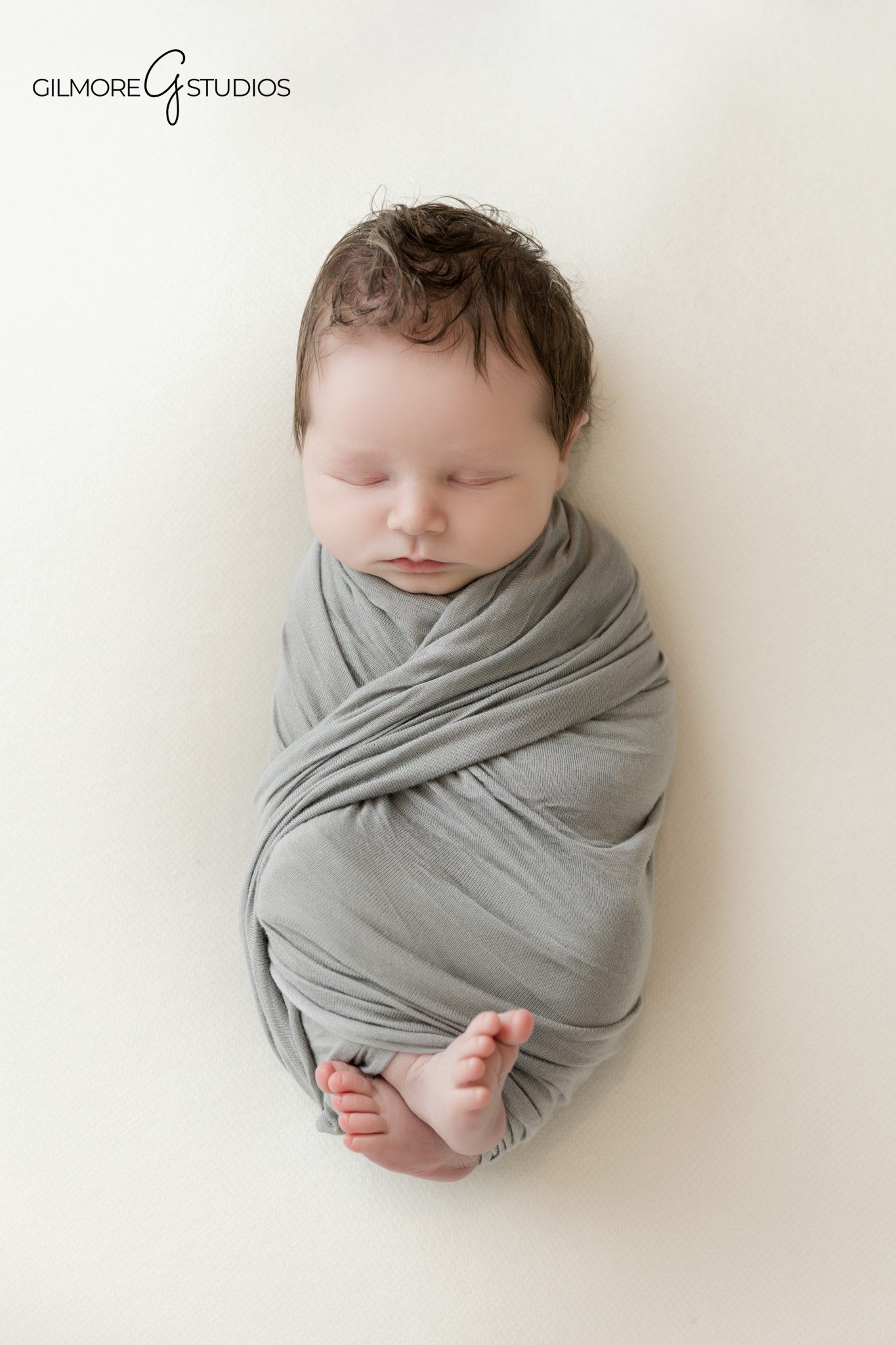 Baby wrapped in gray for timeless newborn photos in Queen Creek
Queen Creek studio newborn session with mom and baby