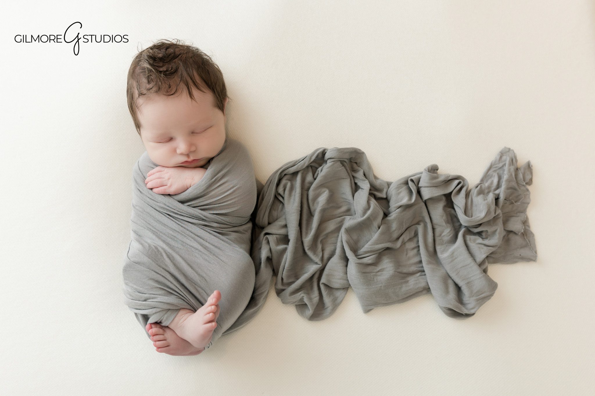 Newborn photography in Queen Creek AZ with baby wrapped in gray
Queen Creek newborn photographer capturing baby with mother in studio