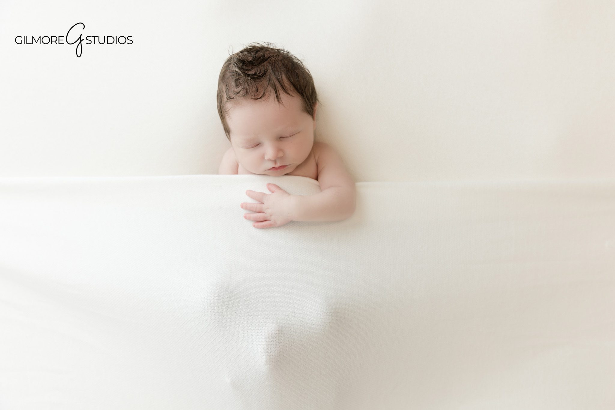 Mother holding newborn baby during Queen Creek studio session
Soft newborn photography in Queen Creek with simple white background