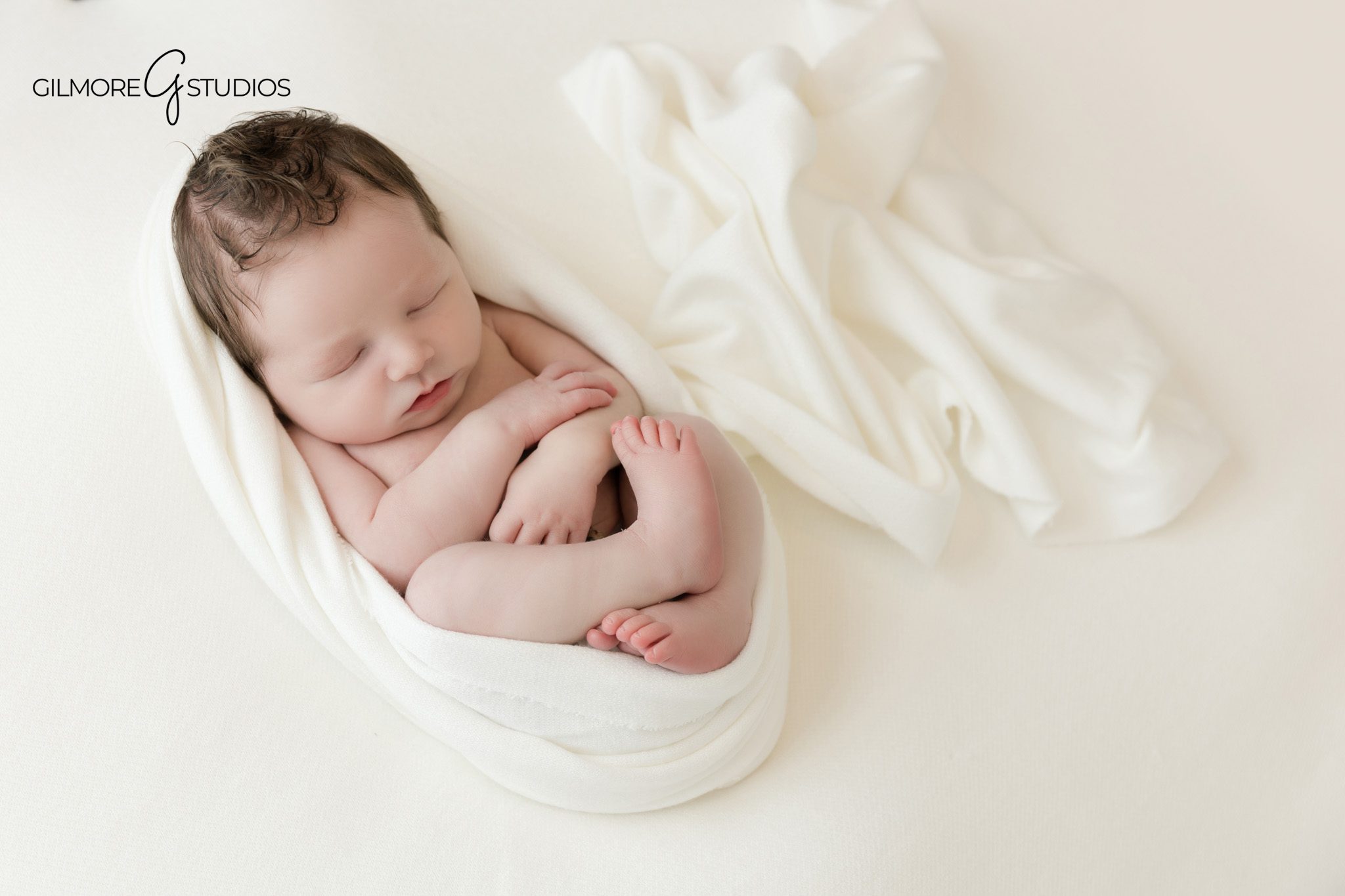Queen Creek AZ newborn photography for growing families
Studio newborn portrait with baby sleeping in gray wrap