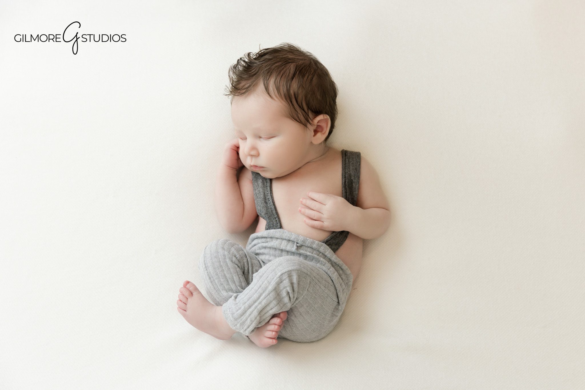 Newborn baby wrapped in gray with smiling older sister
Studio newborn session with sibling portraits on white backdrop