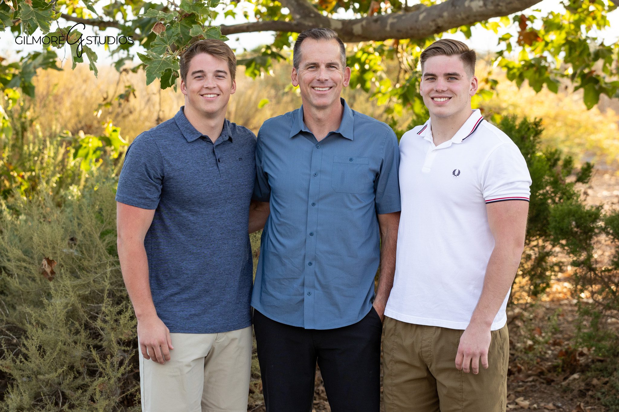 Sibling portrait at Newport Back Bay with greenery and warm light
Four siblings posing together during Newport Beach family session