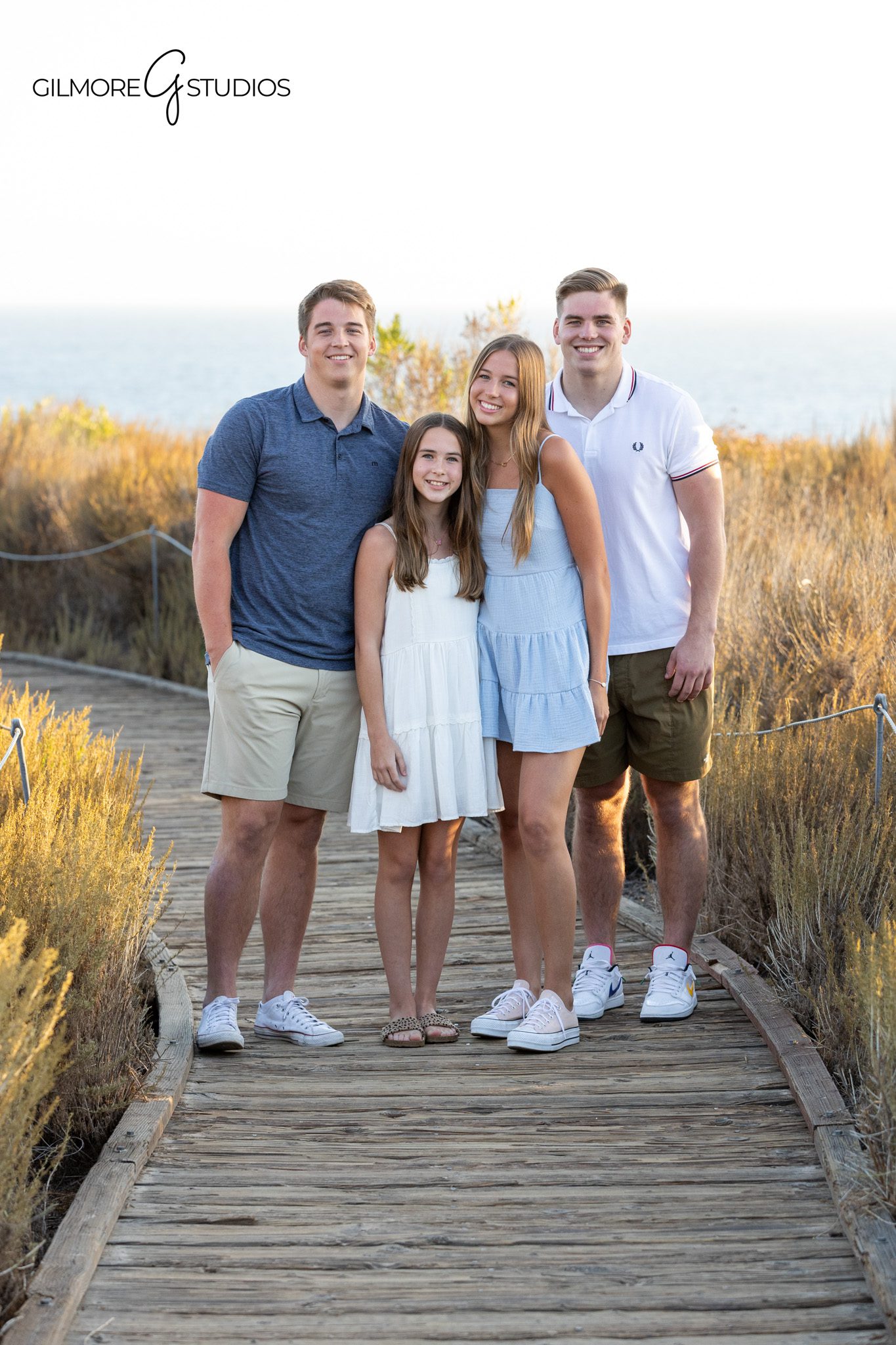 Family of six posing together at Newport Back Bay during golden hour
Coastal family session at Newport Back Bay in Newport Beach California