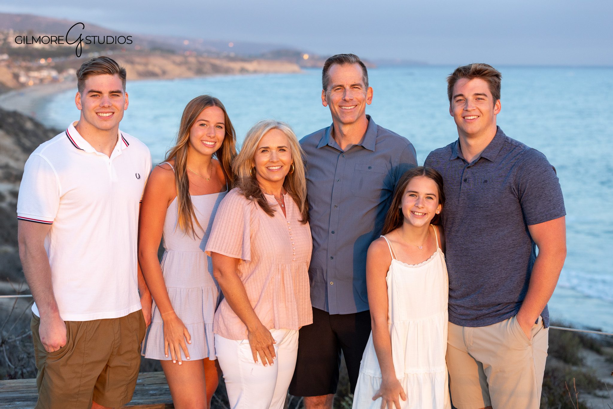 Newport Back Bay sibling photos under a tree during golden hour
Older kids posing together for family photos in Newport Beach