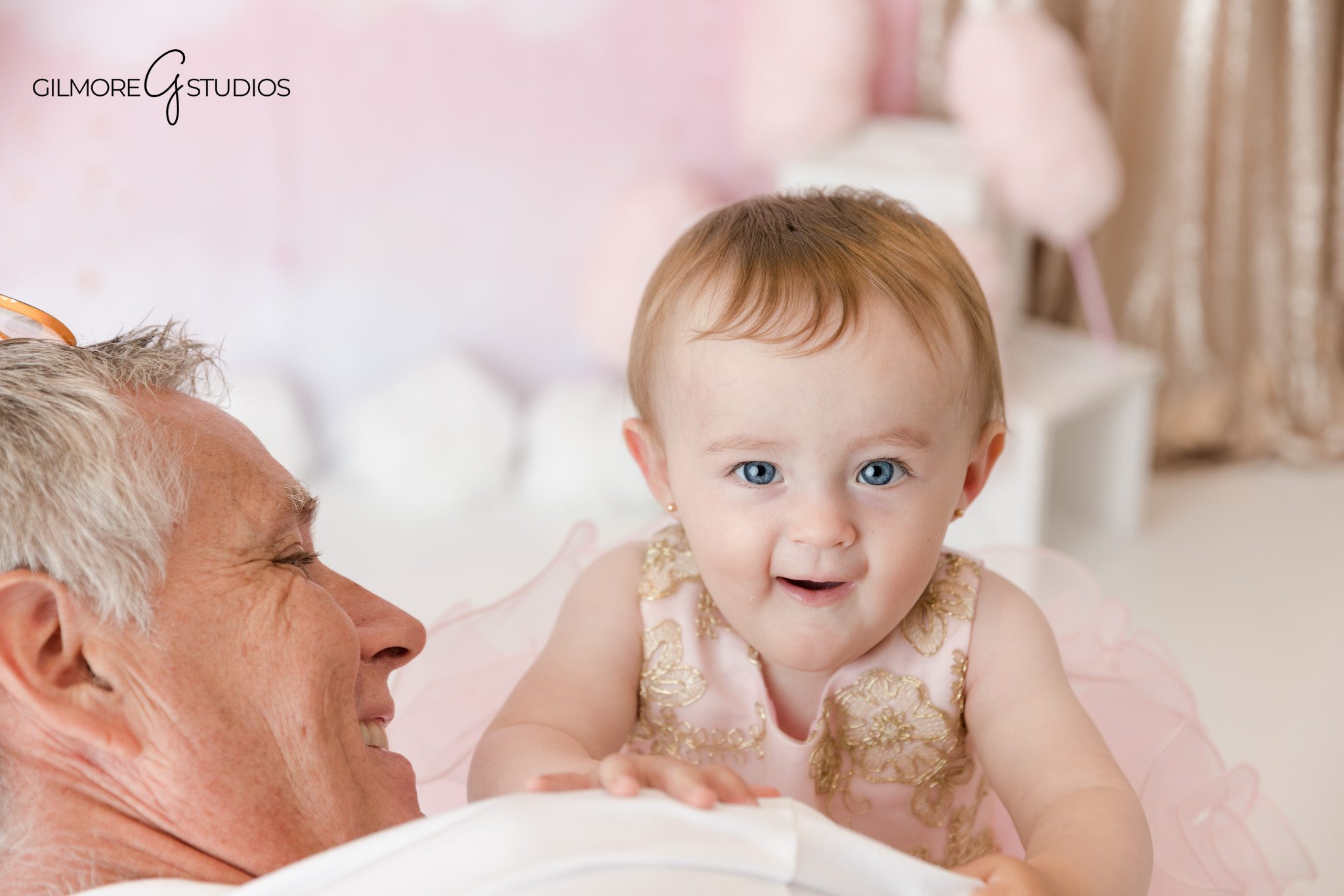 First birthday baby photos with pink cake and ONE letters
Baby girl in pink dress enjoying cake smash session