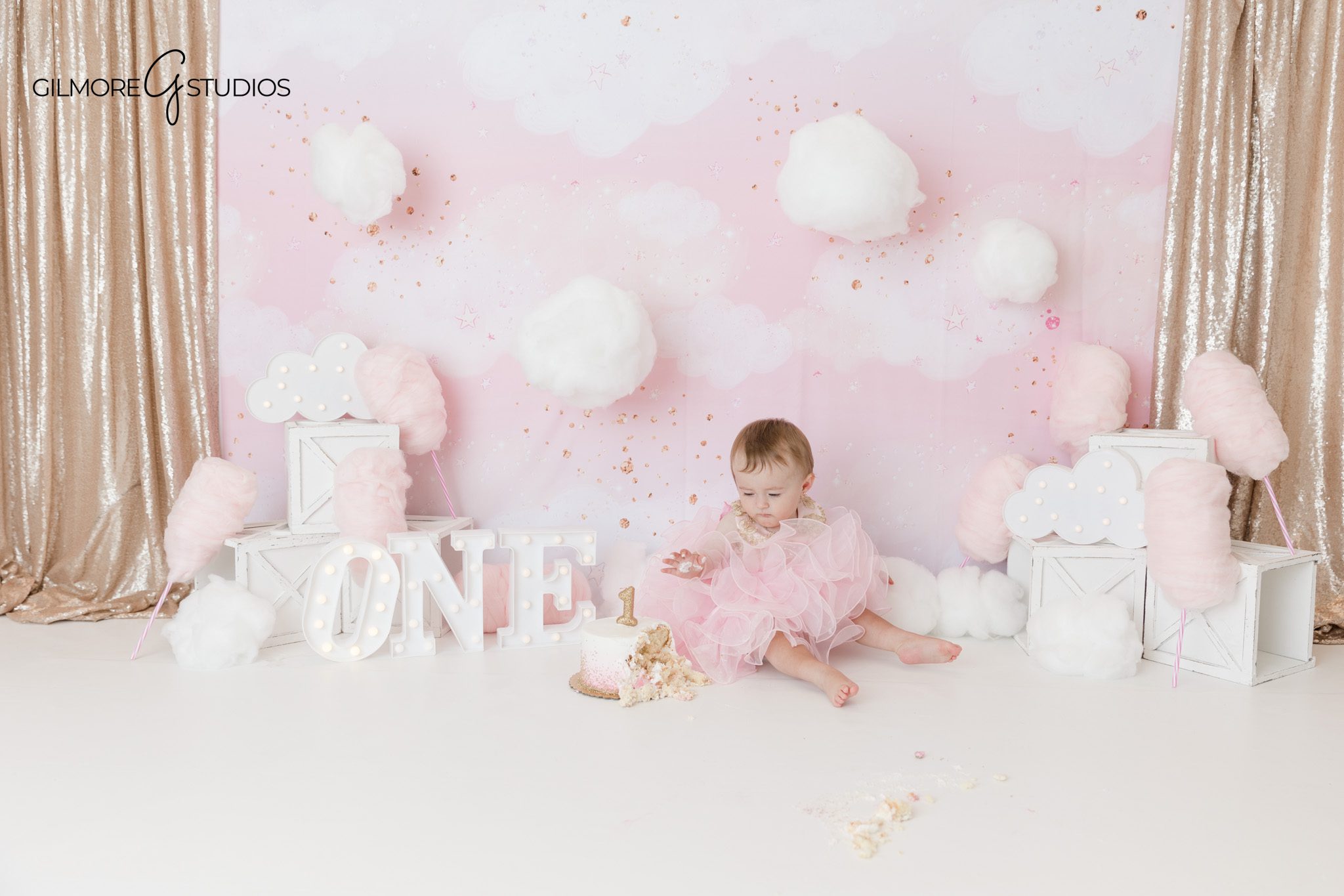 Newport Beach first birthday photography with cake and clouds
Cake smash portrait with baby girl and pastel pink backdrop
