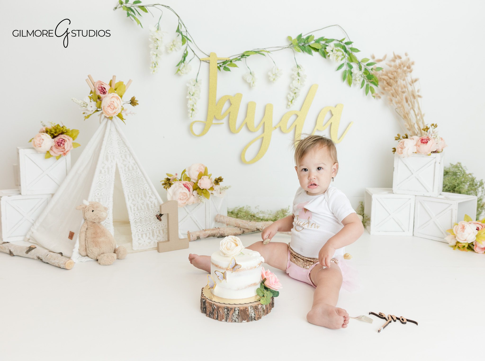 Queen Creek cake smash photographer capturing baby milestone portraits
One year old baby girl smiling during boho birthday session