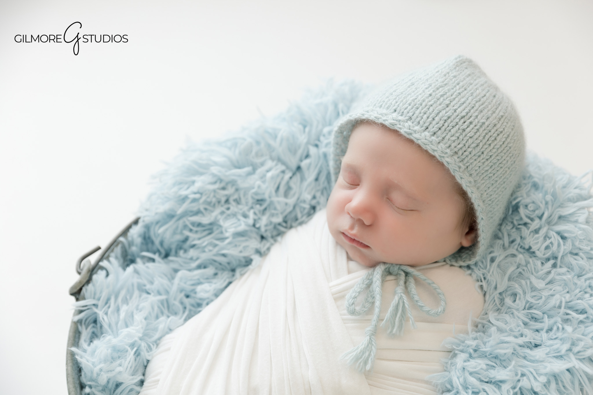 Queen Creek newborn session with white wrap and natural styling
Baby boy newborn photos with soft blue bonnet and white swaddle