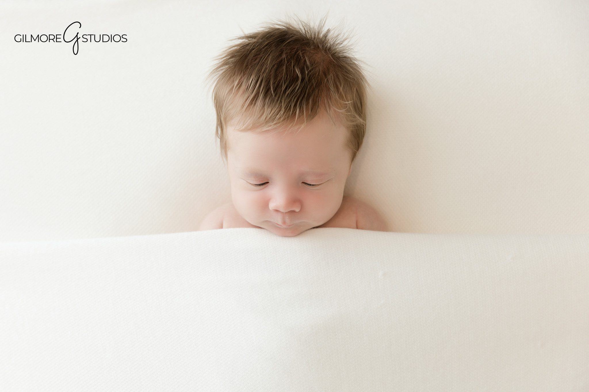 Baby boy sleeping in basket surrounded by colorful airplane props
Queen Creek newborn photographer creating aviation themed baby portraits