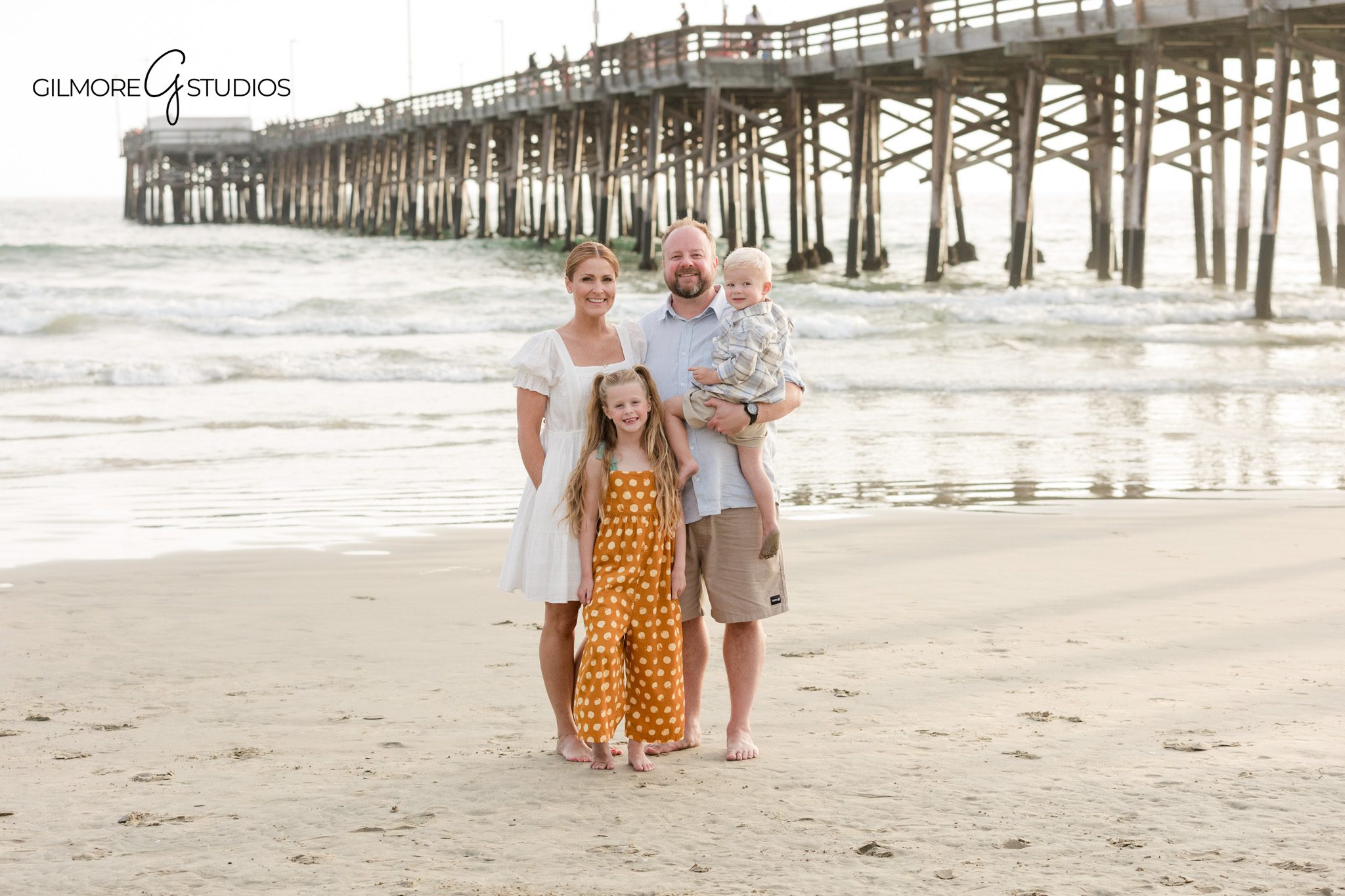 Dad holding son during Newport Beach Pier family photos
Father and children portrait on the beach near Newport Pier