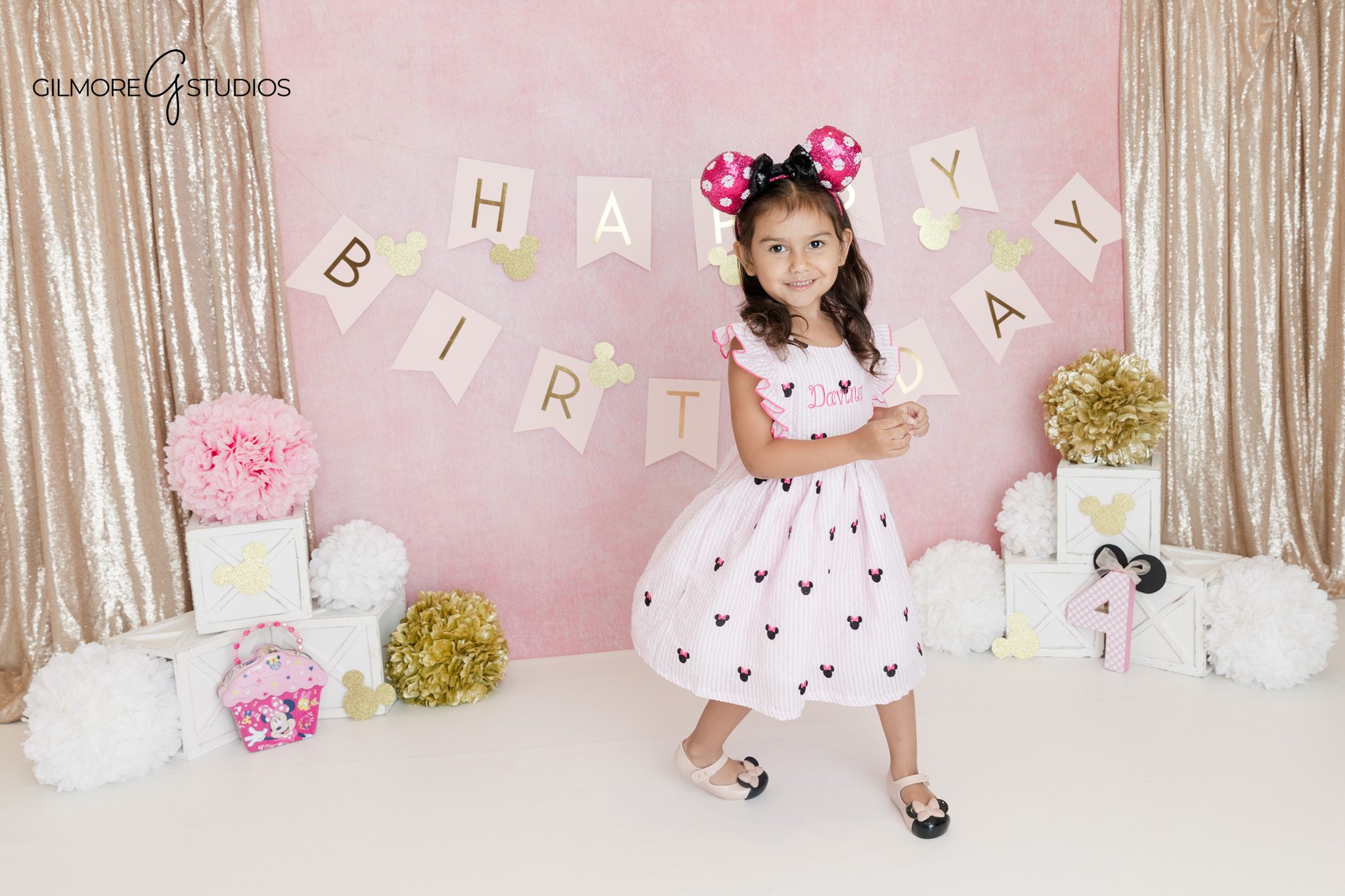 Queen Creek studio birthday portraits with pink and gold decorations
Four year old girl smiling in Minnie Mouse inspired birthday setup