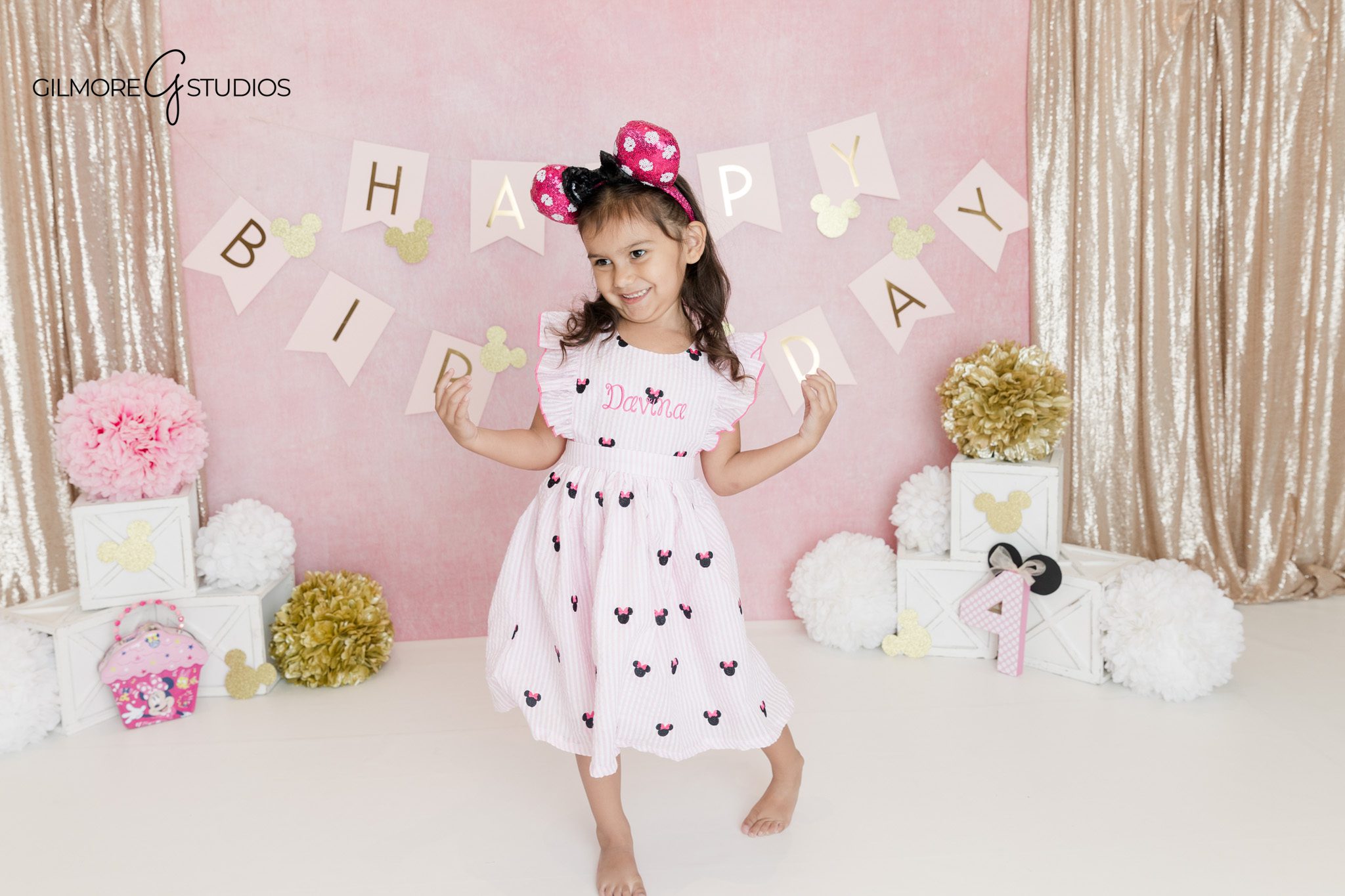Four year old girl twirling in Minnie Mouse inspired birthday outfit
Pink and gold studio birthday photos for little girl in Queen Creek