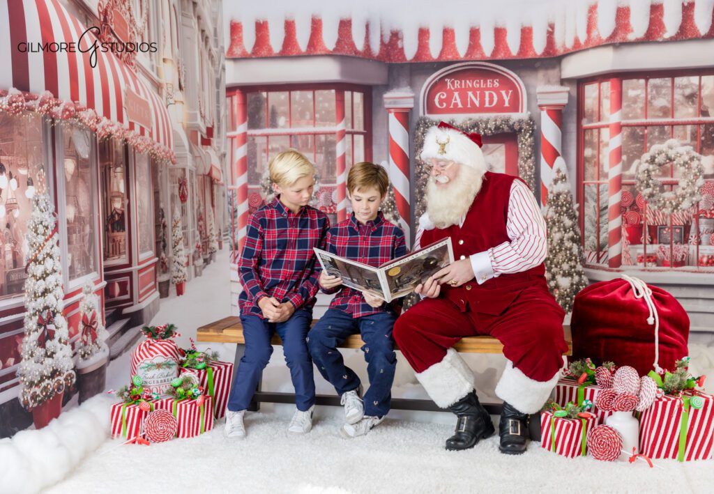 Holiday portrait of brothers with Santa behind window scene
Gilmore Studios Santa mini session with older kids in plaid outfits