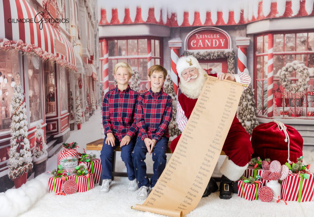 Queen Creek Santa mini session with storybook Christmas moment
Brothers looking at Christmas book with Santa behind window frame
