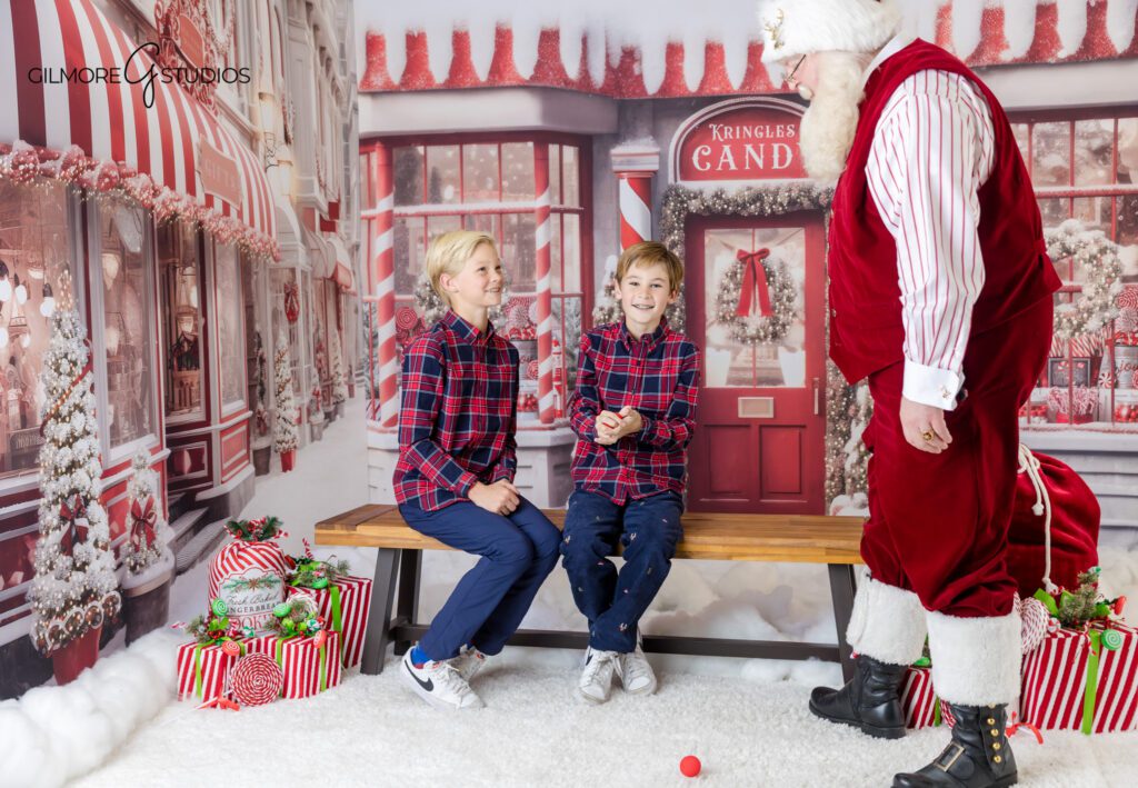 Two brothers holding cookies with Santa during holiday photos
Queen Creek Santa photographer capturing older kids with Santa