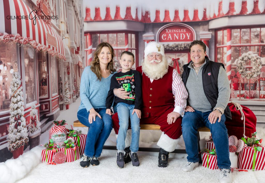 Boys enjoying cookies with Santa during Christmas session
Santa mini session showing older children still love Christmas photos