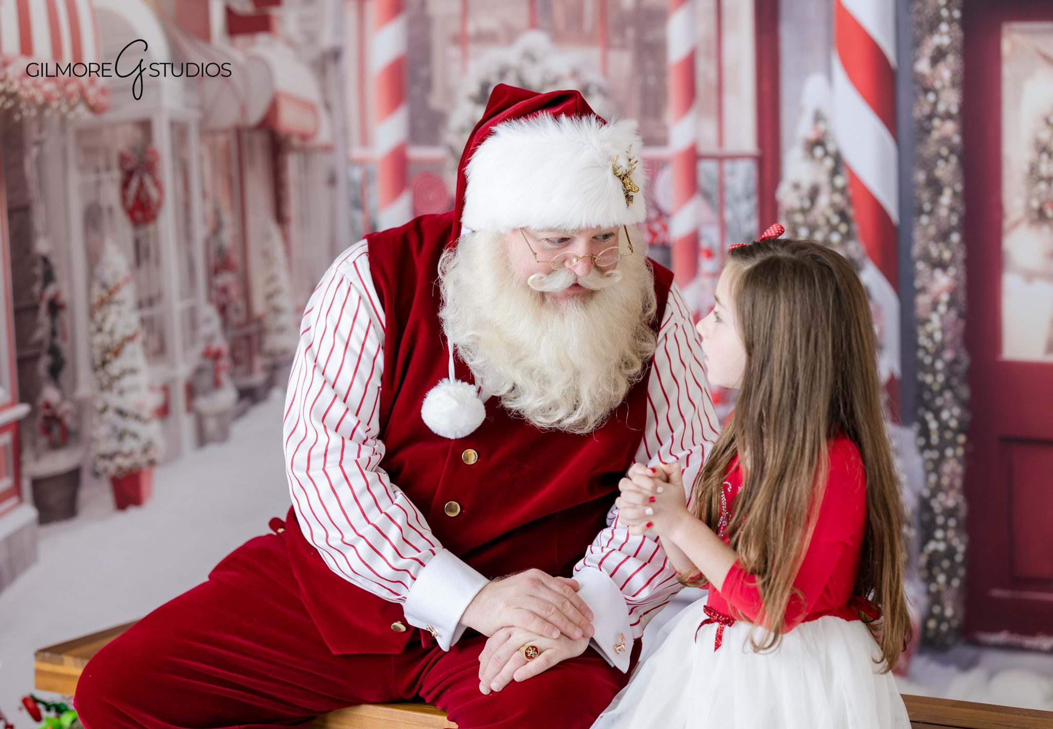 Gilmore Studios Santa photos with children and classic Christmas set
Queen Creek Santa photographer capturing sisters with Santa on holiday bench