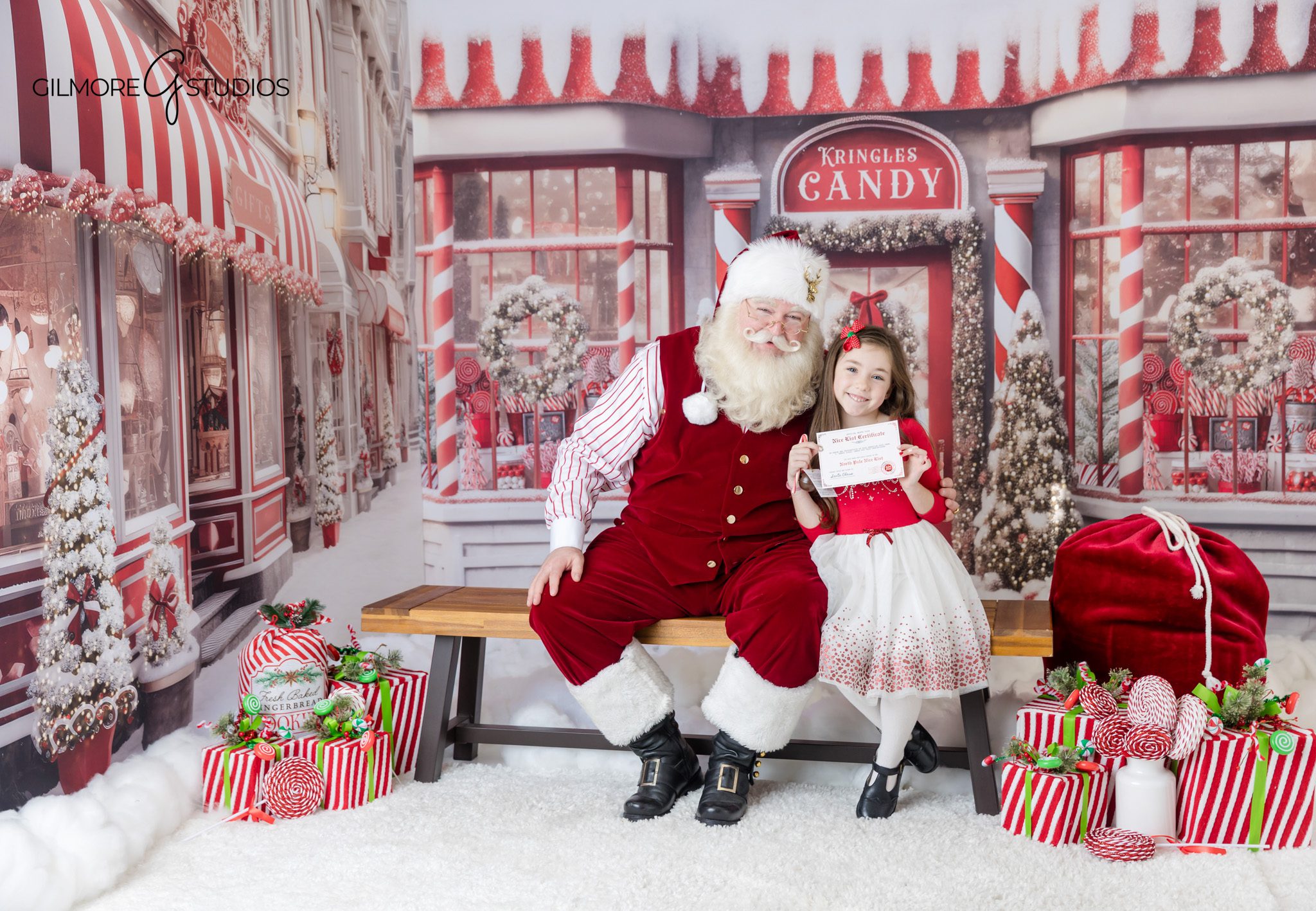 Queen Creek Santa mini session with girl in red and white Christmas dress
Santa and child reading a Christmas book on a holiday set
