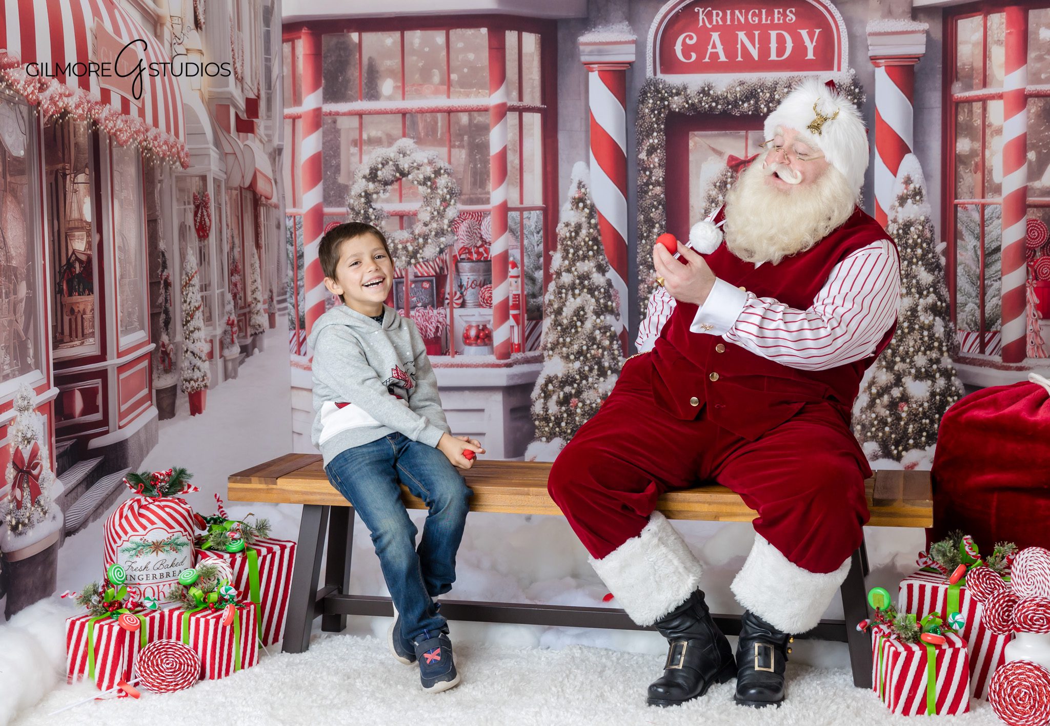 Santa mini session with child and Christmas scroll
Gilmore Studios Santa experience with nice list photo