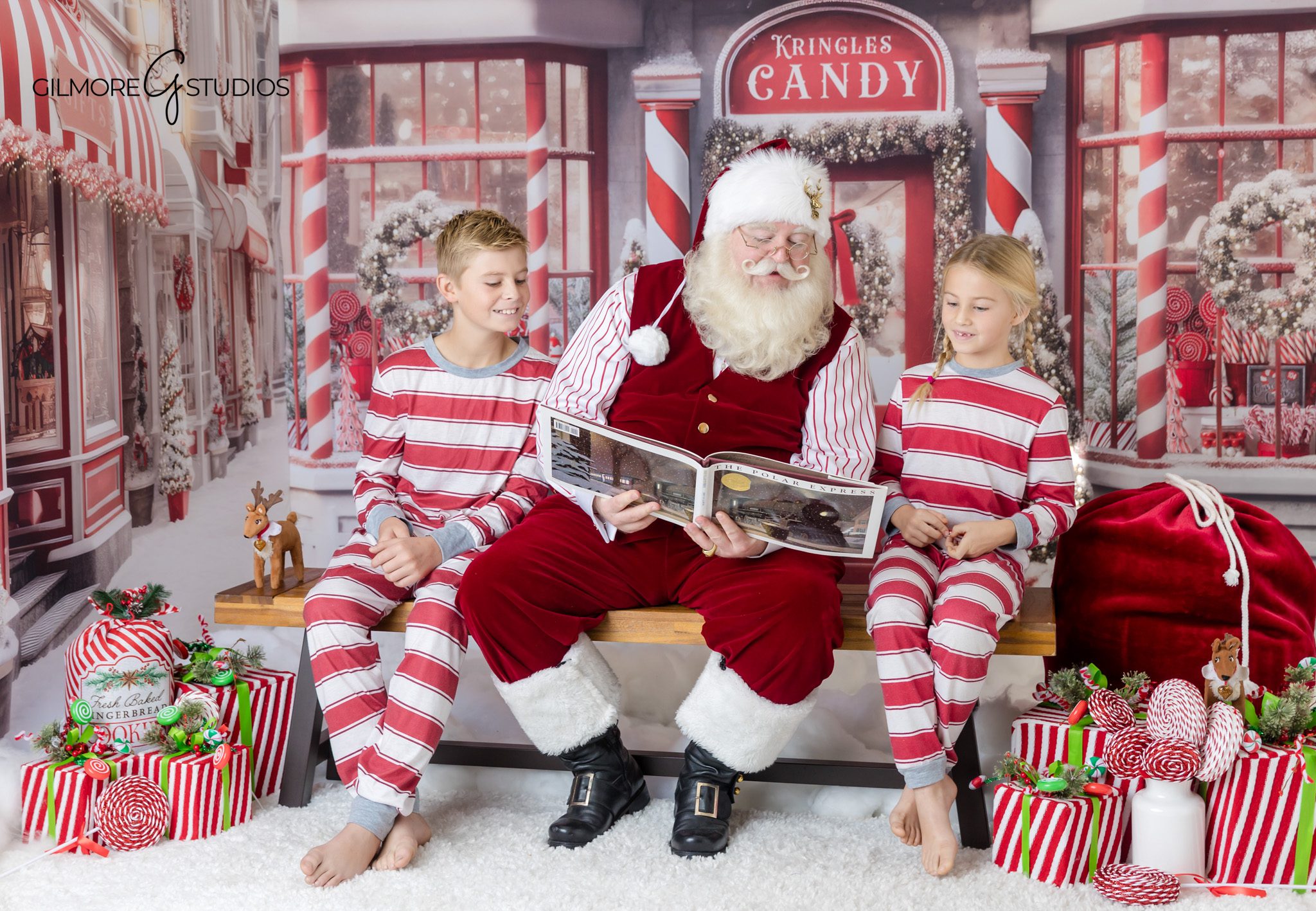 Little girl pointing to Santa’s nice list during holiday session
Gilbert AZ Santa photos with nice list and candy shop backdrop