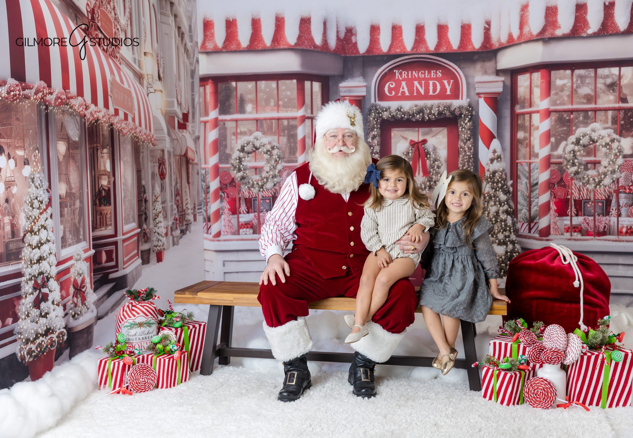 Queen Creek Santa photographer creating interactive Christmas portraits
Children looking at Santa’s nice list during a mini session