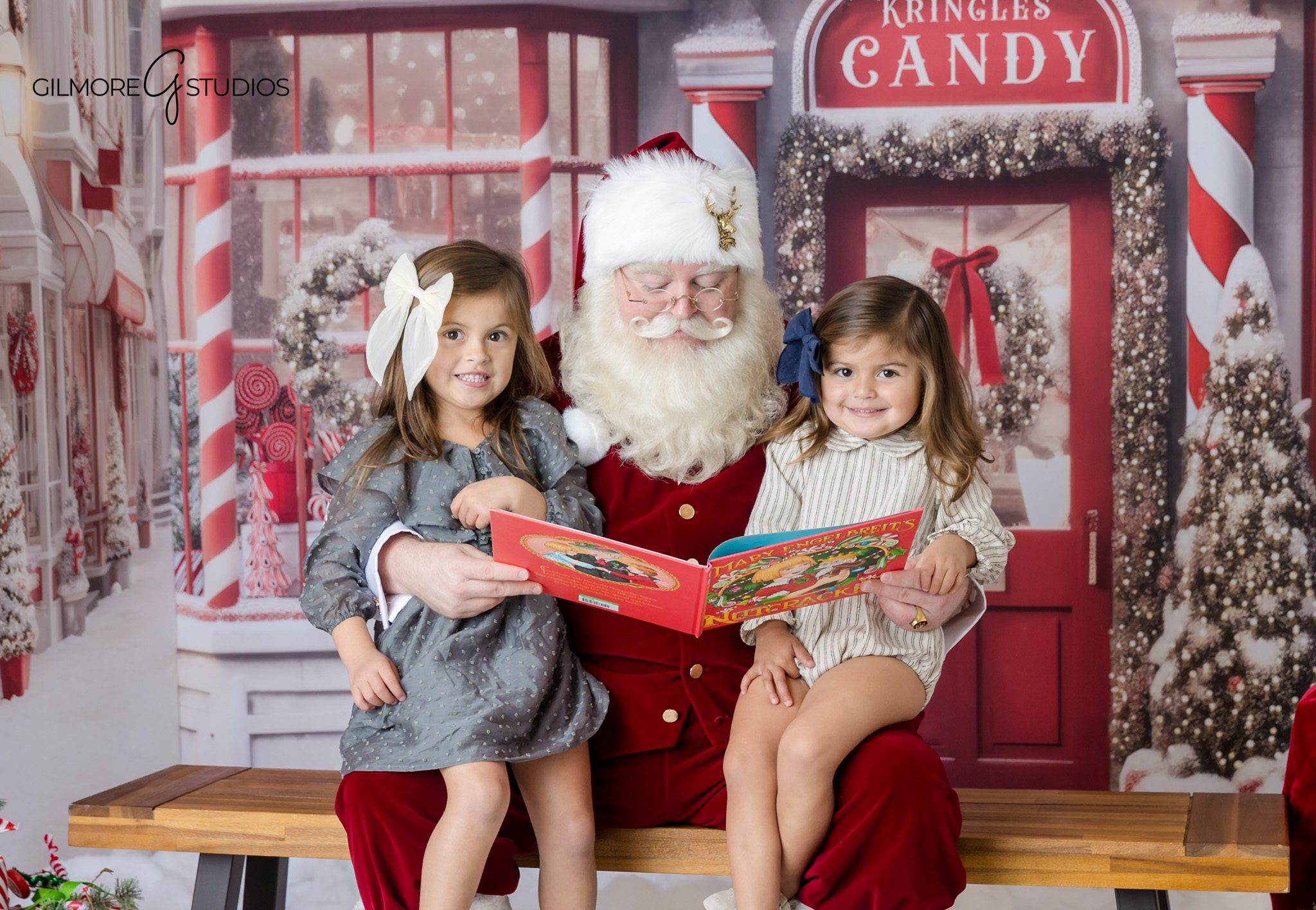 Queen Creek AZ Santa mini session with two sisters sitting with Santa
Santa mini session in Queen Creek Arizona with festive candy shop backdrop