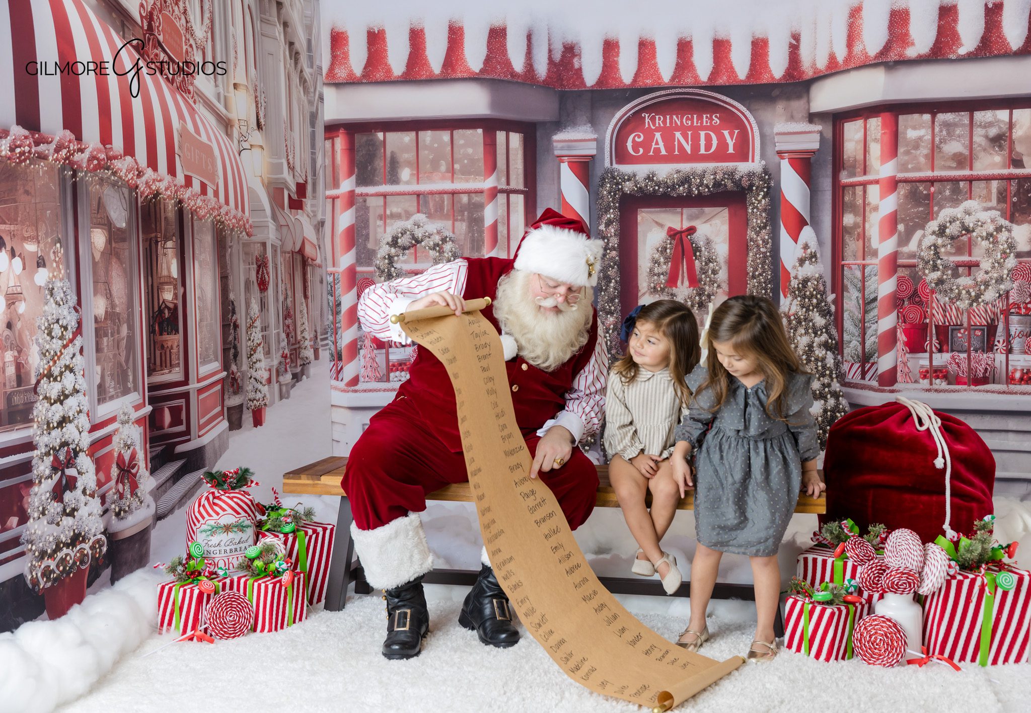 Sisters smiling with Santa during a holiday mini session in Queen Creek
Santa mini session with snow window effect at Gilmore Studios