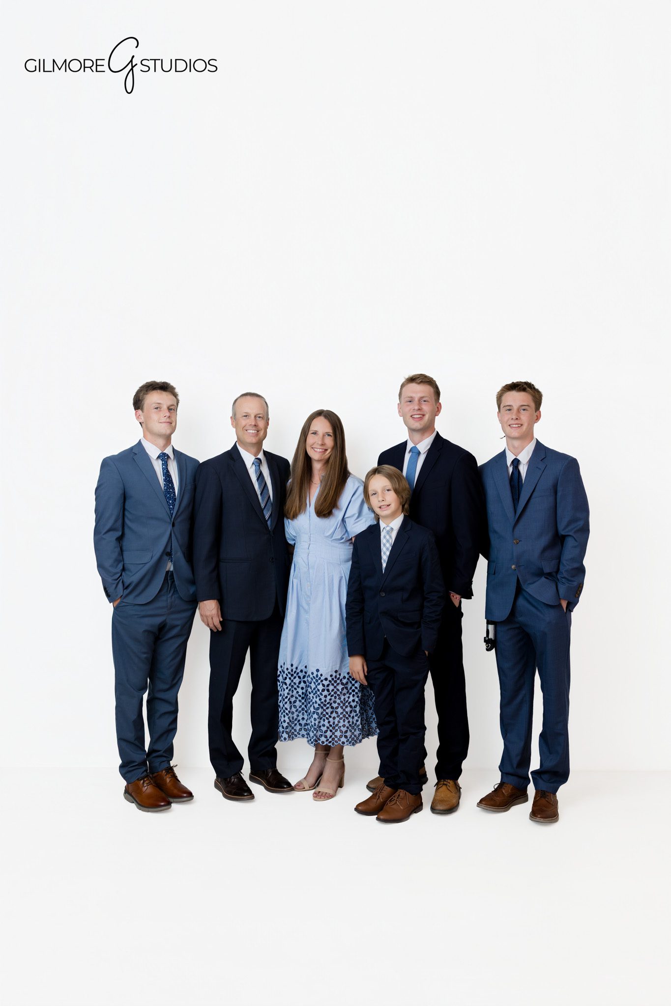 Gilmore Studios family photography session with older kids before leaving home
Queen Creek studio family photos with navy suits and soft blue wardrobe