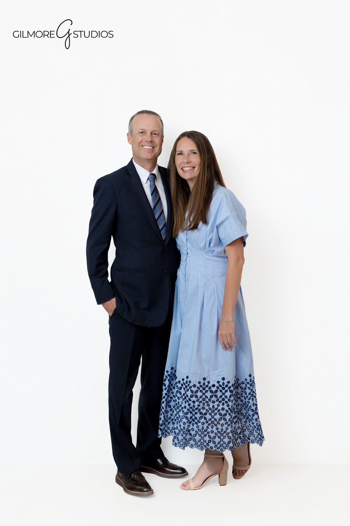 Studio family portrait with navy suits, blue ties, and soft neutral styling
Queen Creek family photographer creating formal and relaxed portraits