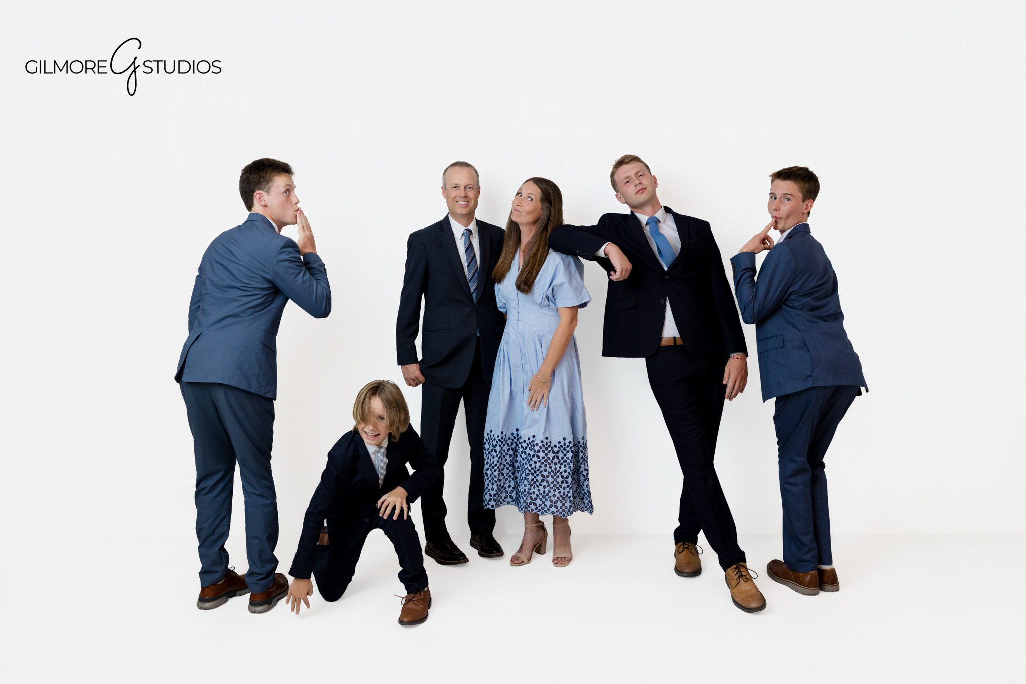 Queen Creek family photographer capturing parents with their teenage and adult sons
Studio family portrait with older children and coordinated blue outfits