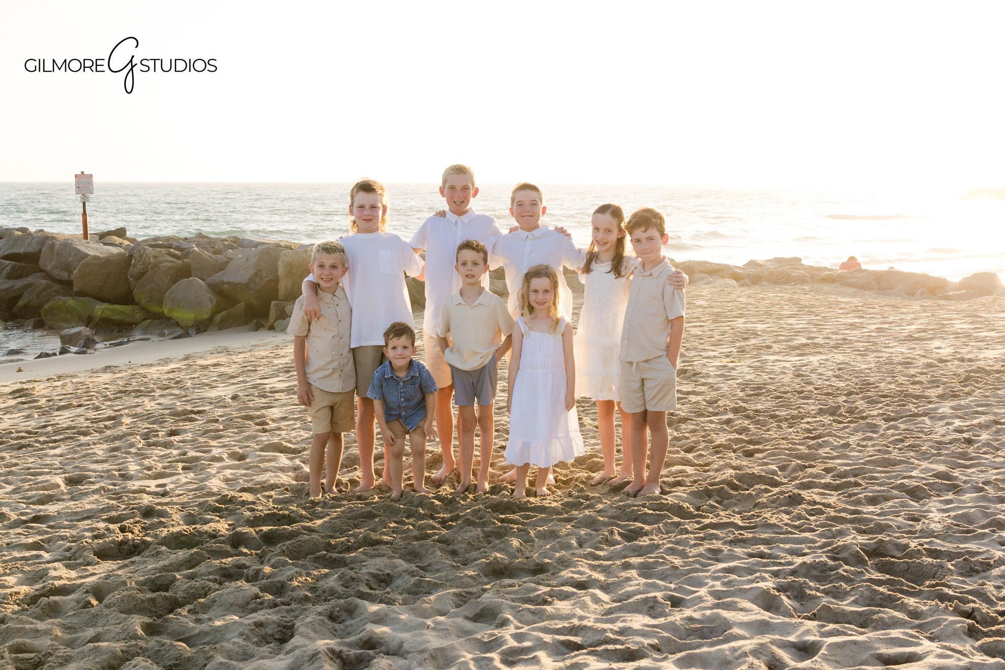 Newport Beach photographer capturing individual family portraits at the beach
Family of five standing together in front of ocean waves