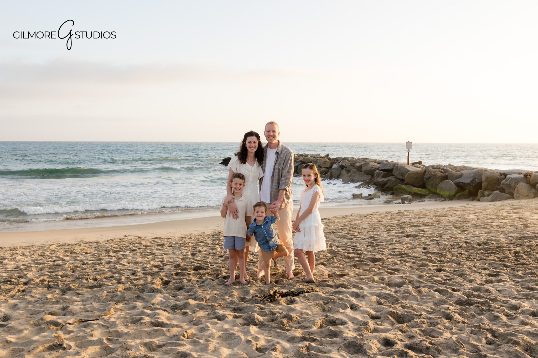 Large group family photos at Newport Beach during golden hour
Newport Beach extended family session with coordinated coastal outfits