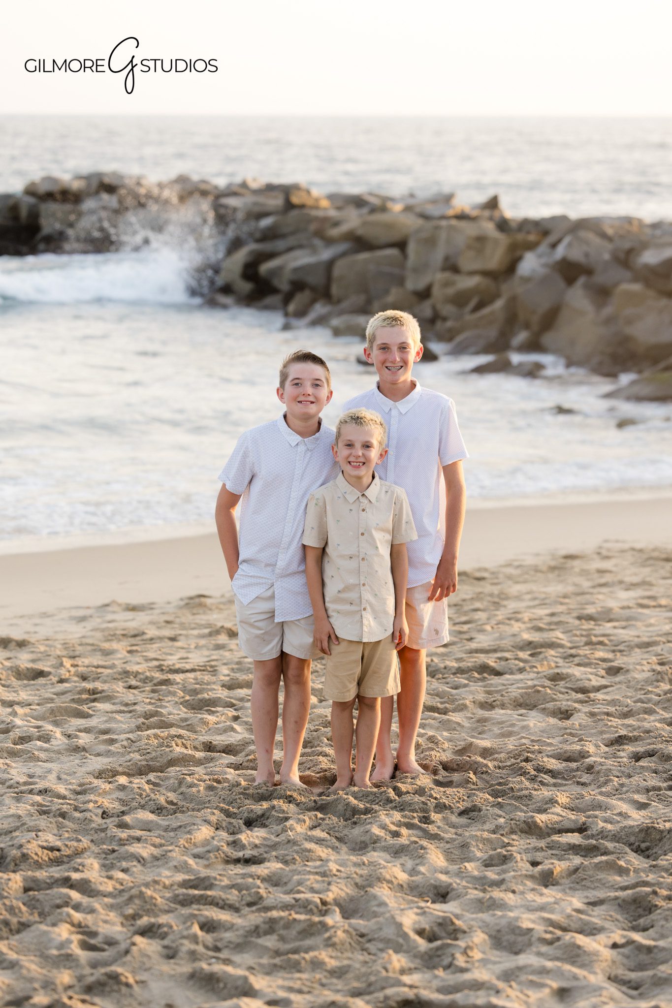 Cousin group portrait near the Newport Beach jetty at golden hour
Newport Beach extended family session with kids posed near the ocean