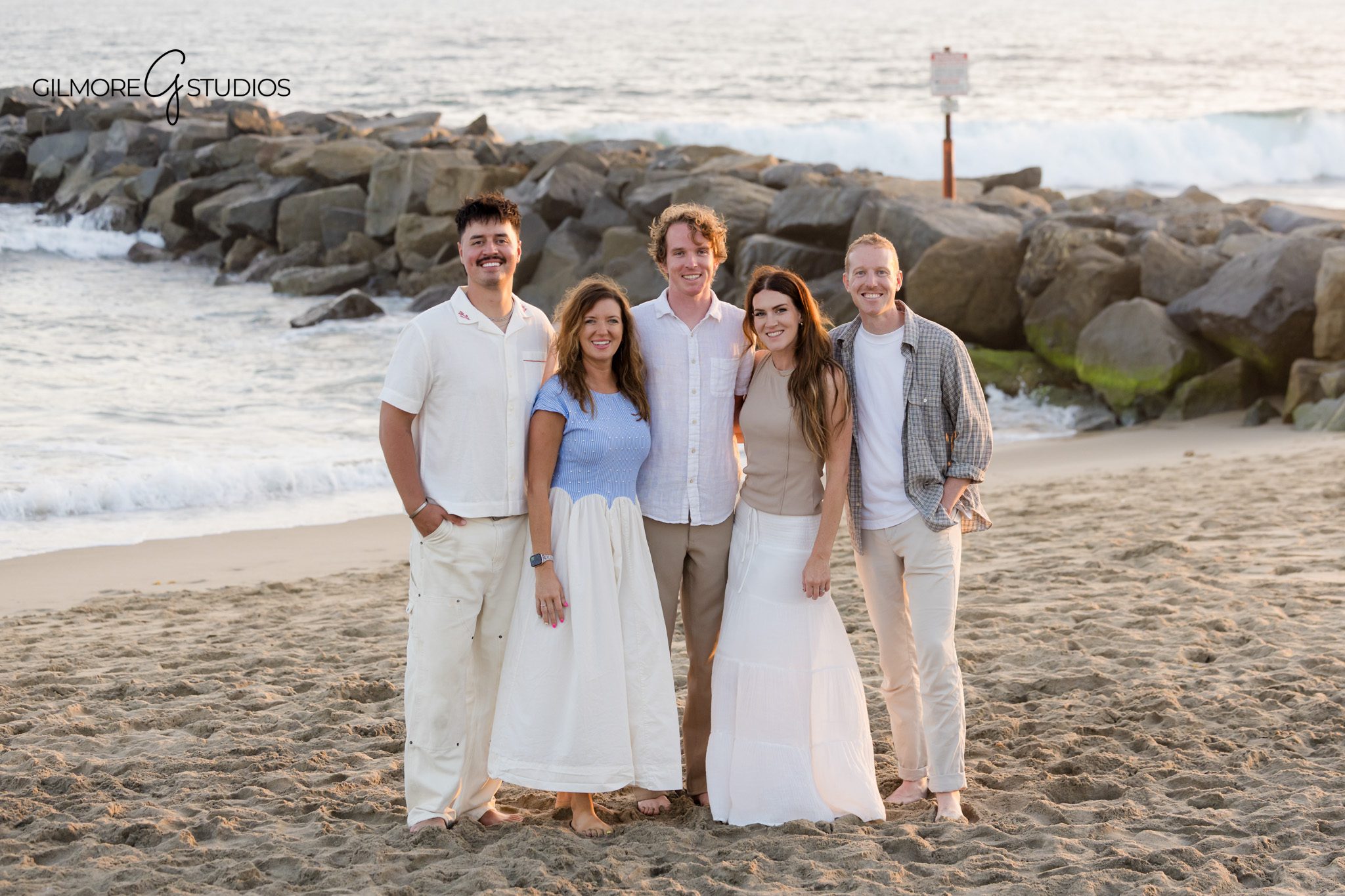 Newport Beach vacation photography for parents and young children
Beach family photo with kids in neutral outfits and white dress