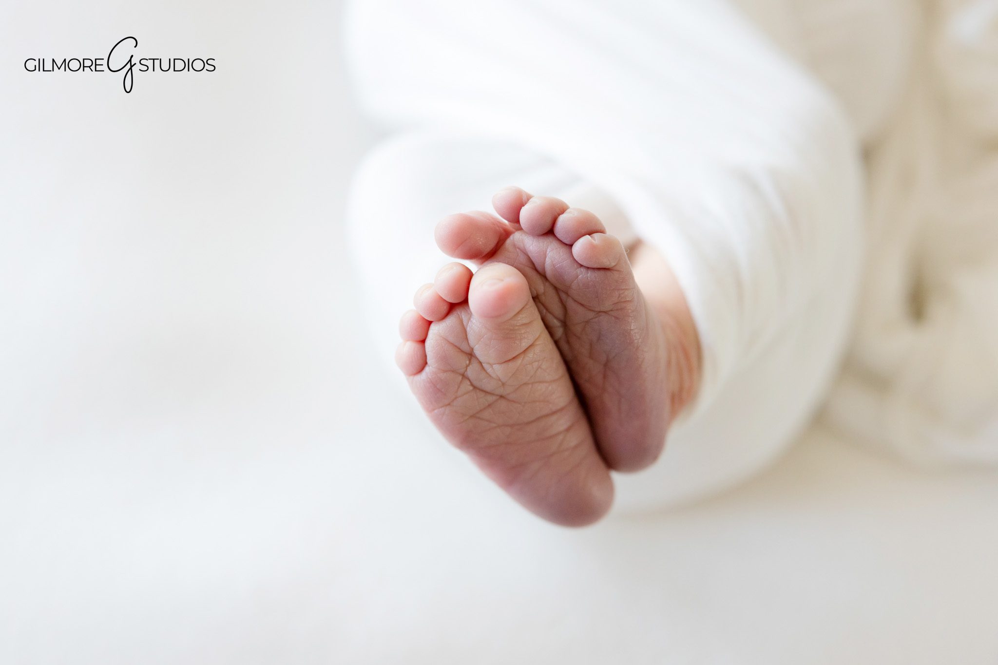 Baby boy posed with hockey stick and puck during newborn session
Newport Beach newborn photo with personal family prop