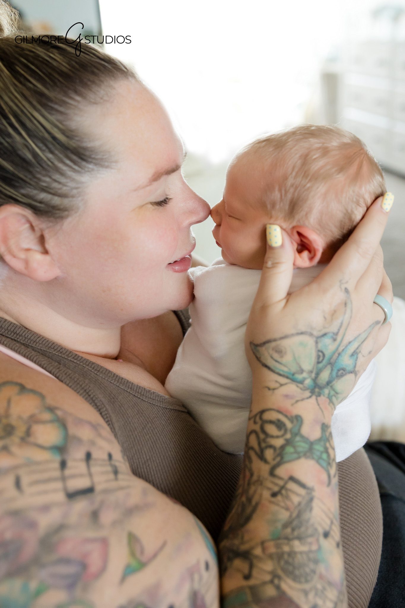 Lifestyle newborn photo of dad holding sleeping newborn
Mother and baby portrait during at-home newborn photography session