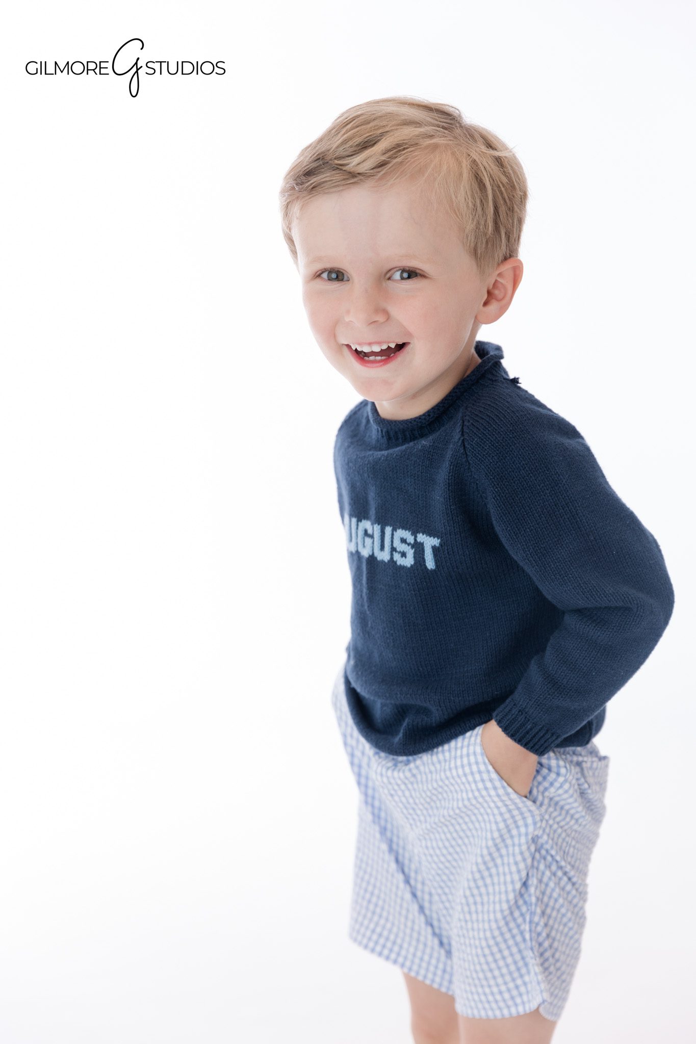 Studio personality portrait with simple timeless styling
Little boy sitting on white studio floor for portraits