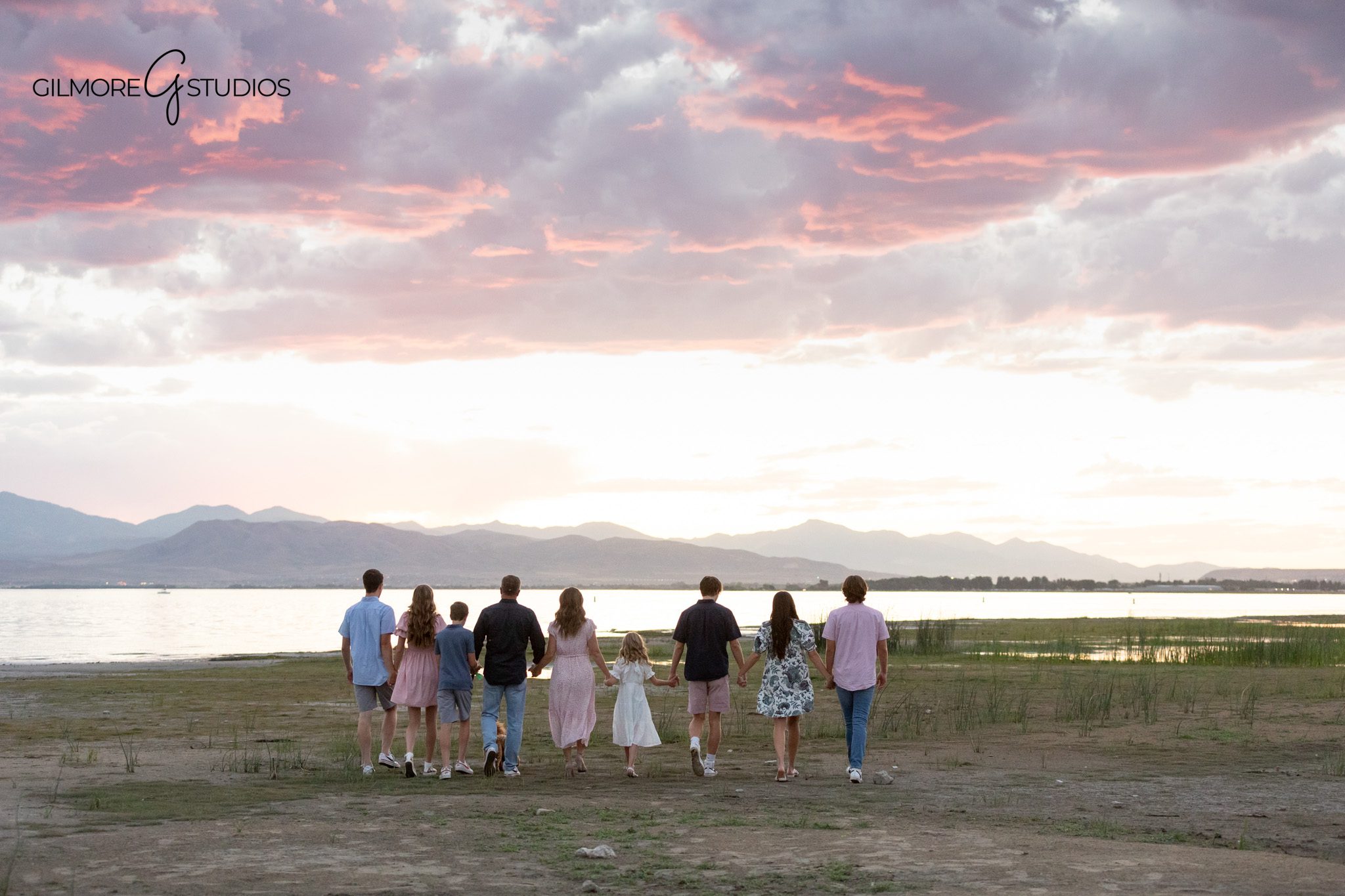 Mom surrounded by her children during lakeside family photos
Candid family photo with kids laughing around their mom