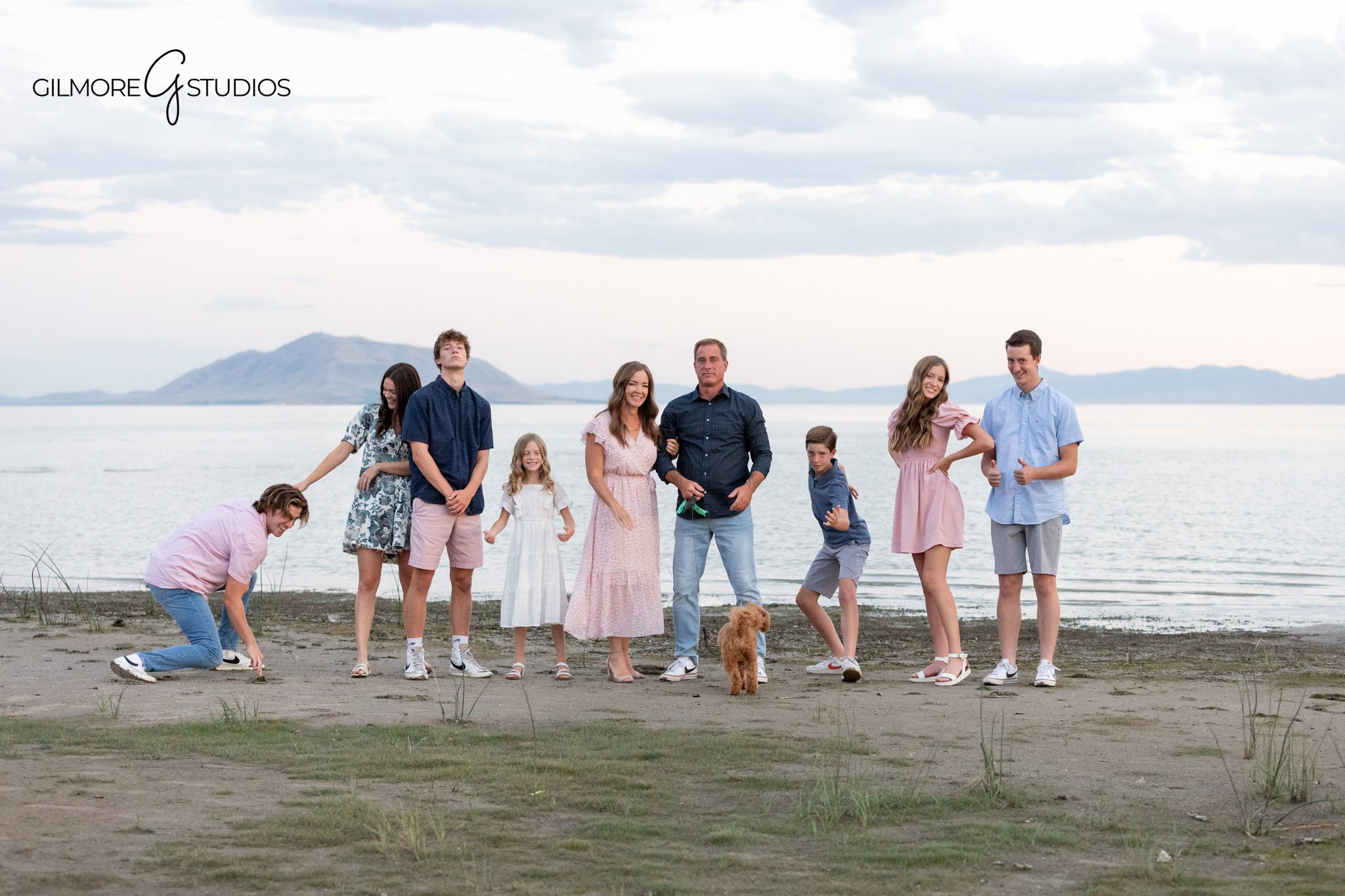 Large family with small dog posing in front of mountain scenery
Family photos with older children and dog during Utah session